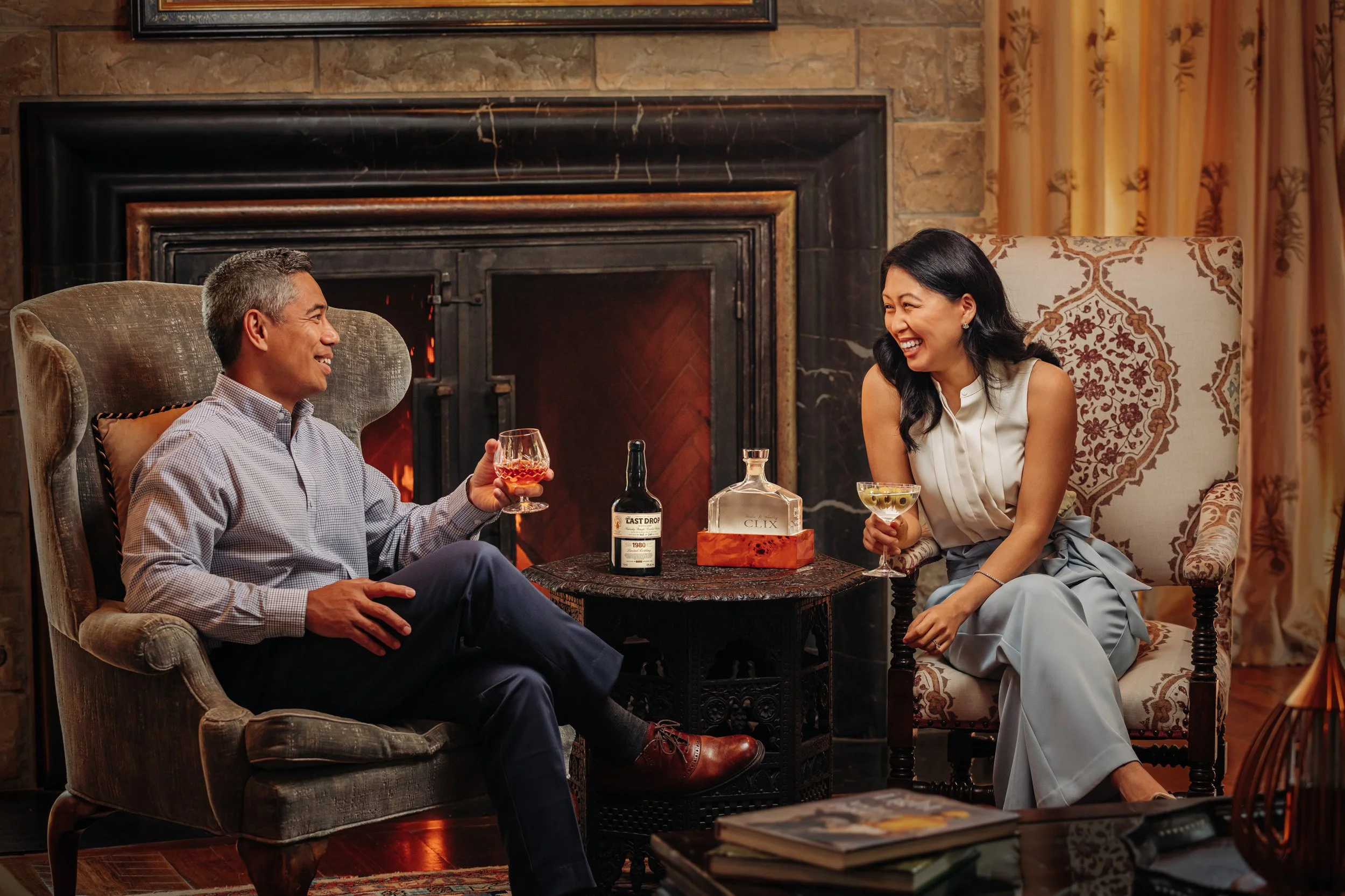 Woman and Man drinking cocktails by fire