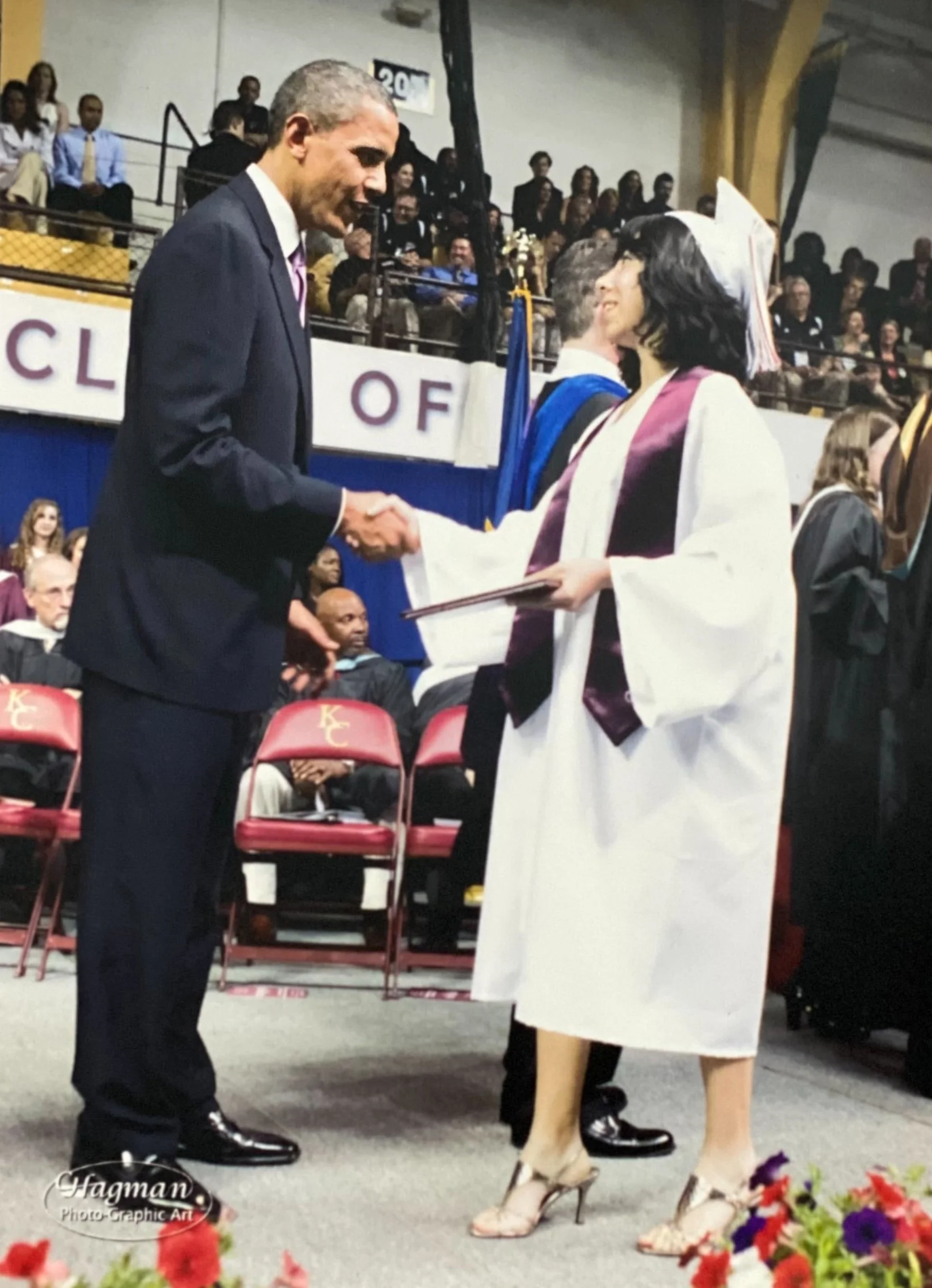 Perla shaking hands with former President Barack Obama after receiving her high school diploma in 2010.