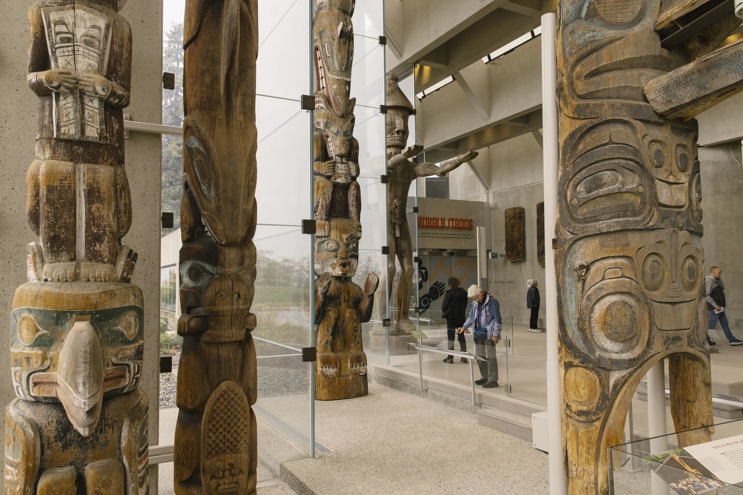 A visitor reads about Indigenous art at the MOA in Vancouver