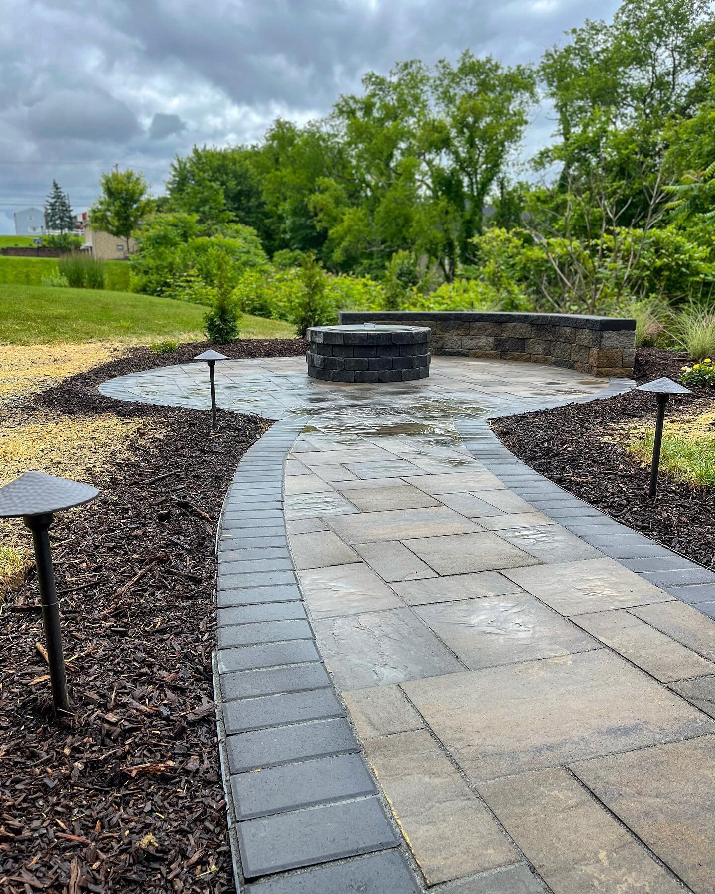 Customers kids were getting too old for the old rotten playground so he decided he wanted a nice hangout spot for his family! So we went and built him this beautiful patio with a seating wall, Breeo fire pit, walkway with all new landscaping around!
