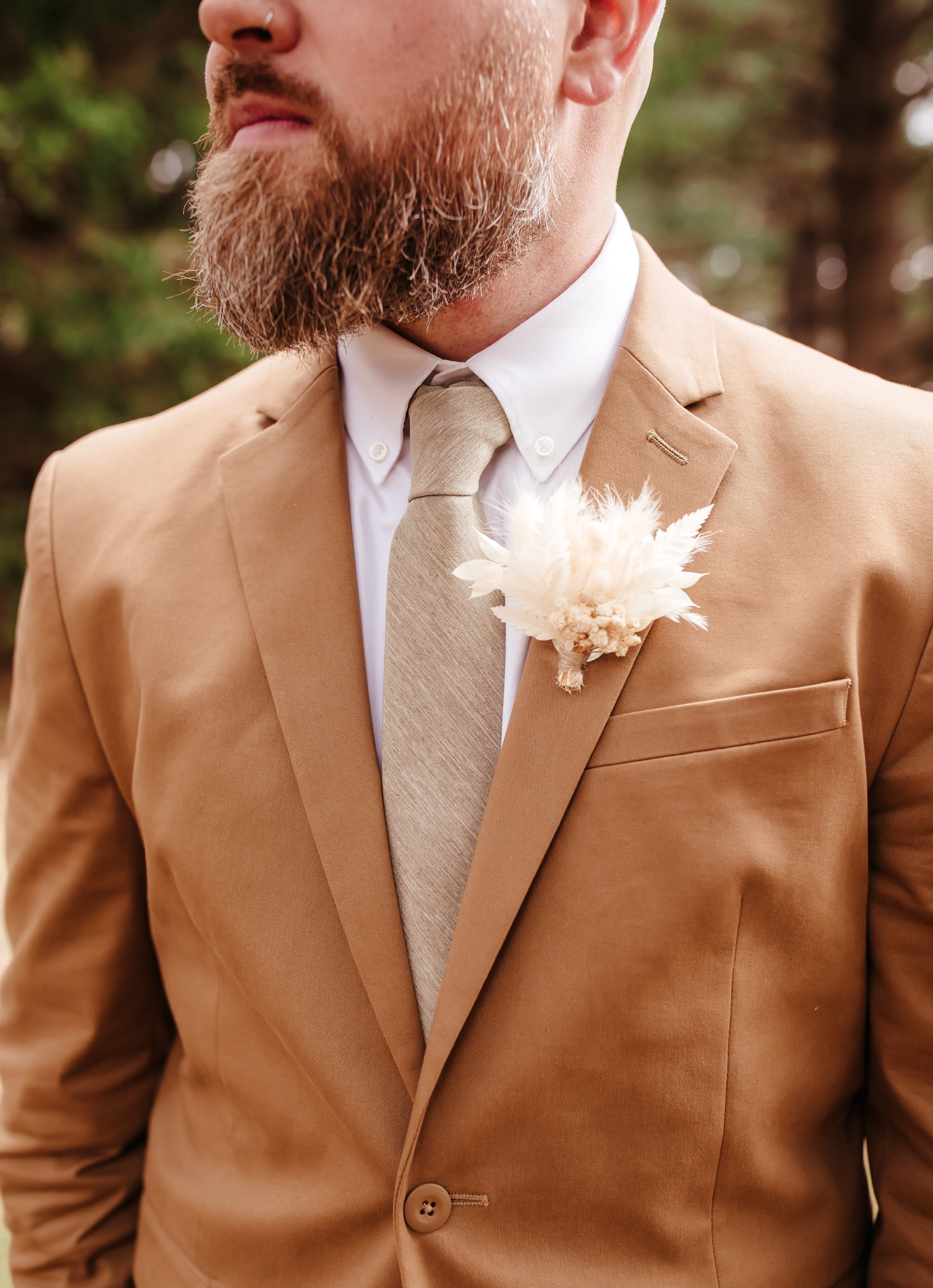 Groom in tan &amp; brown  suit with dried boutonniere 
