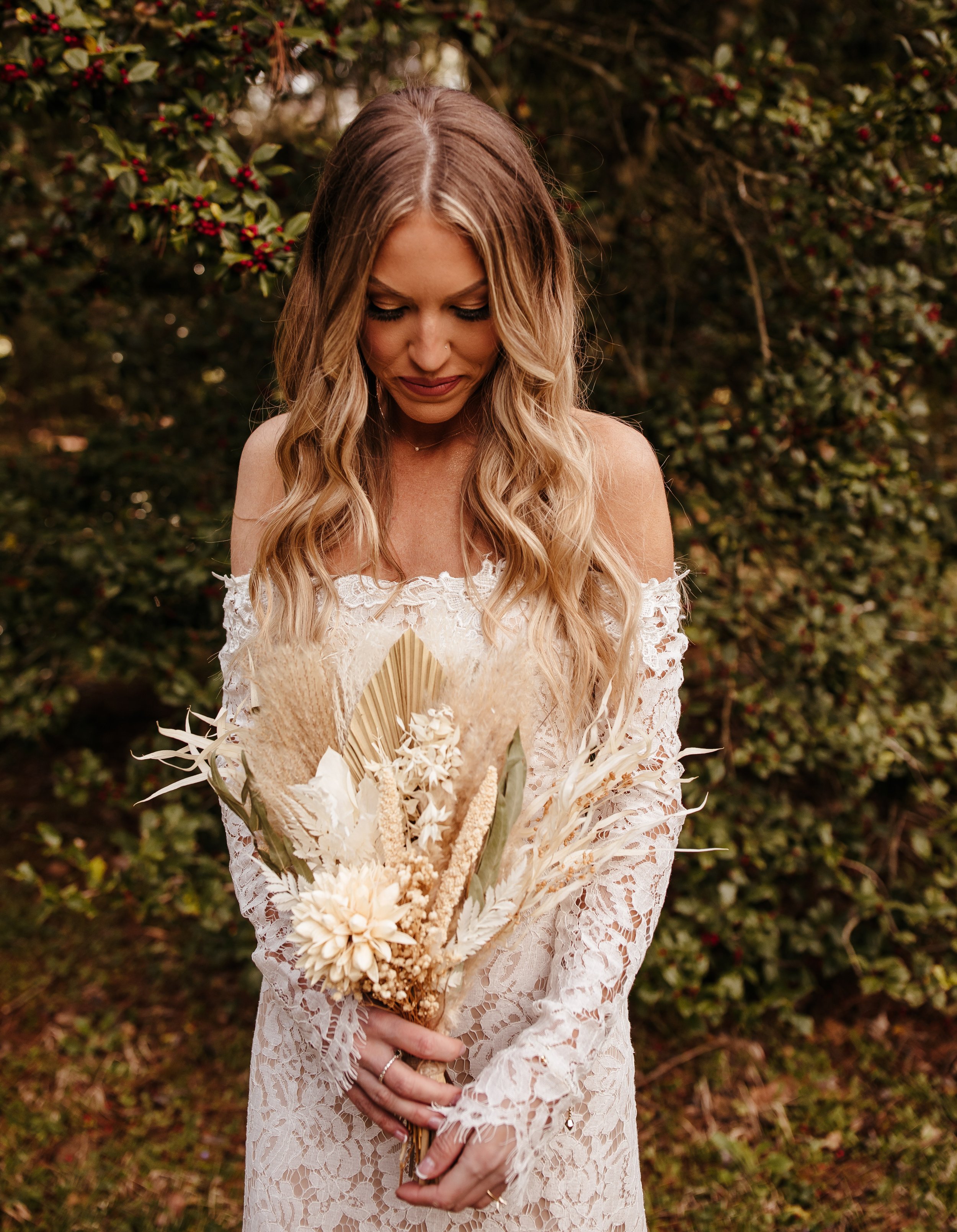 Southern Indiana elopement bride in lace wedding dress, hat and dried florals