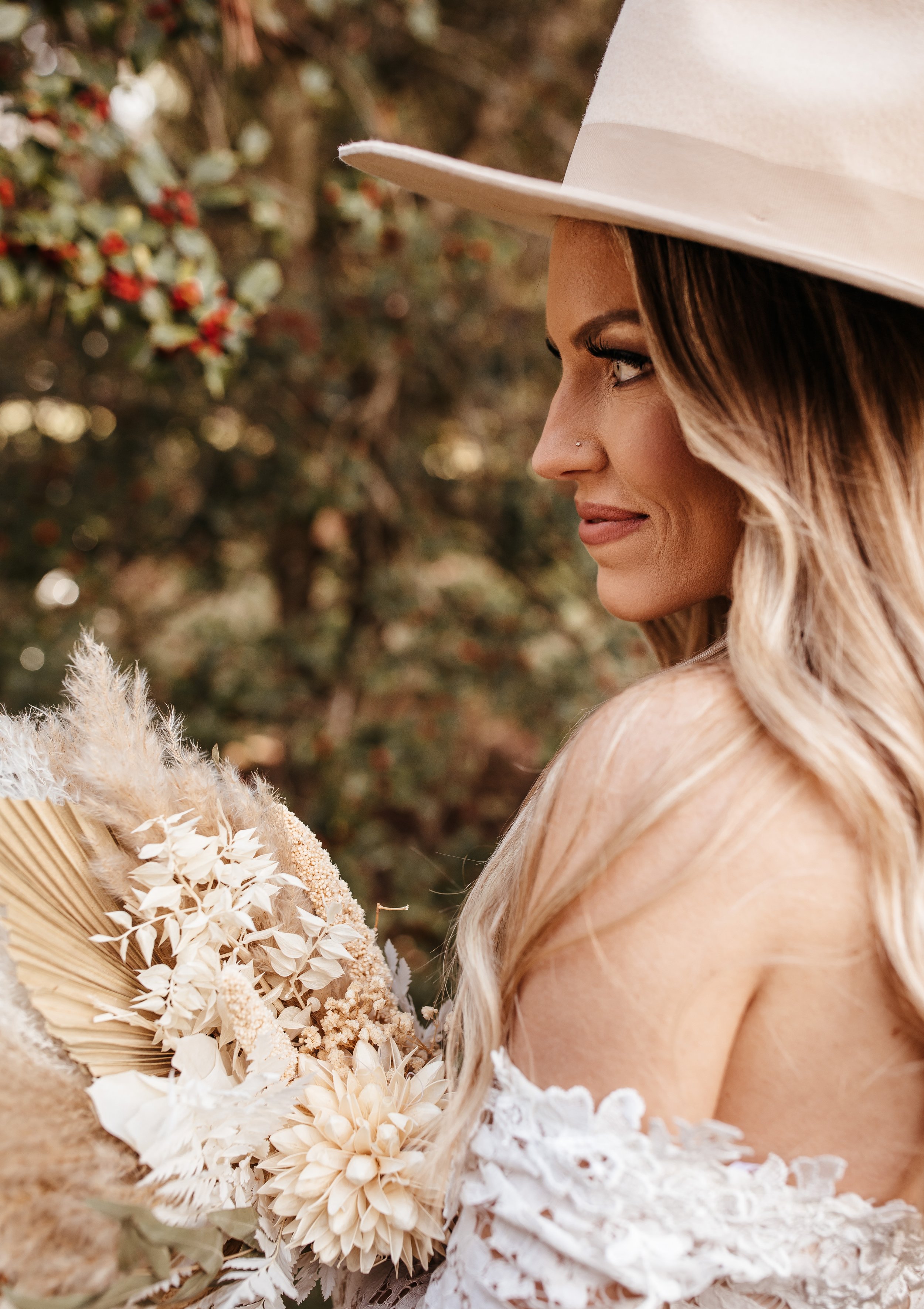 Southern Indiana elopement bride in lace wedding dress, hat and dried florals