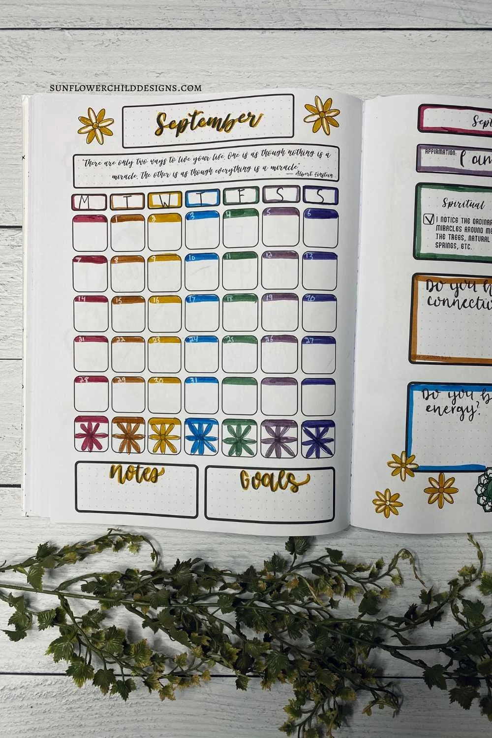 September bullet journal calendar spread with a chakra theme, featuring a quote at the top and guided inspiration banks for monthly planning.