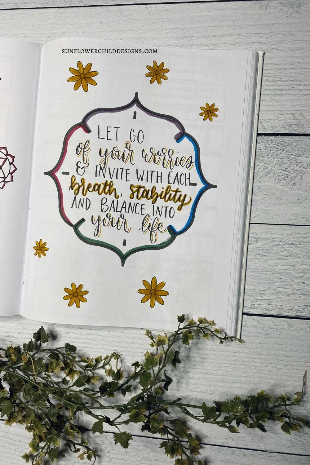 September bullet journal quote page featuring a chakra theme with seven muted colors representing each chakra in a witchy aesthetic layout.