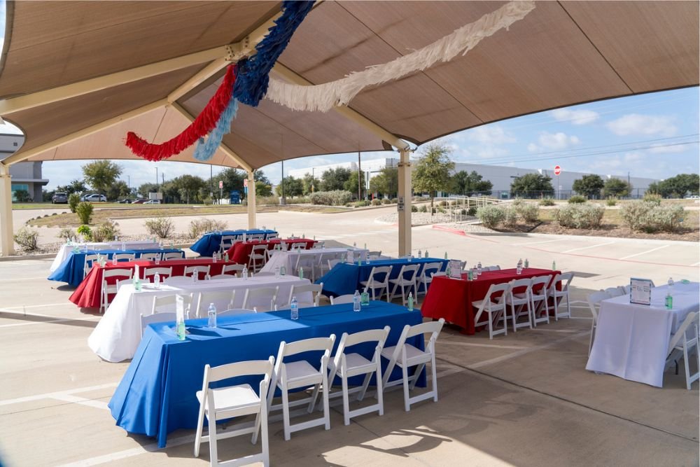 Outdoor pavilion decorated with fringe and red, white, and blue table linens