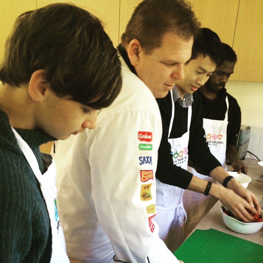 Chef Adam supervising burger making.