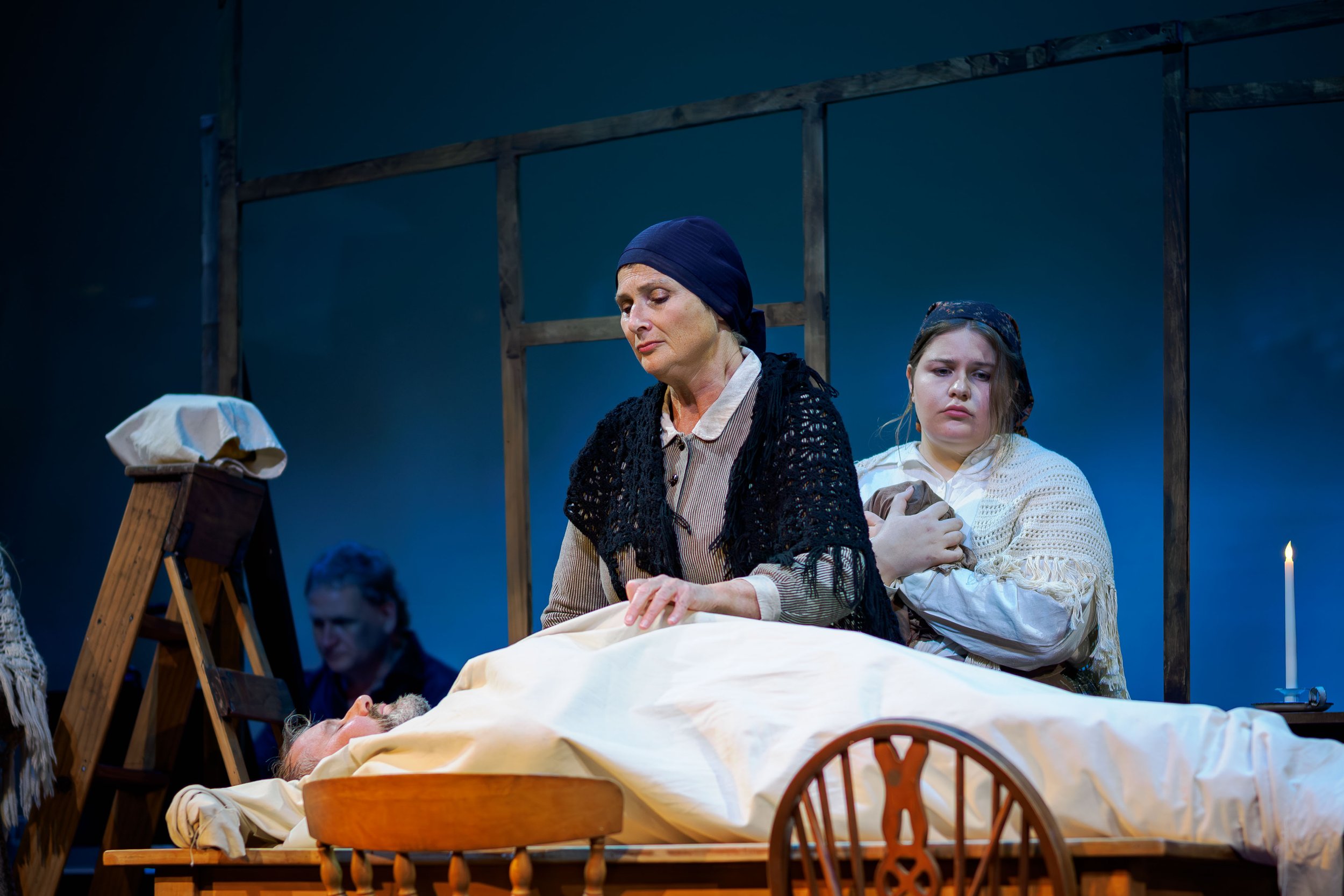 Louisa Pilkington (as Maurya) and Erin Connelly-Whyte (as Cathleen) sing over the body of Bartley (Nigel Withington)
