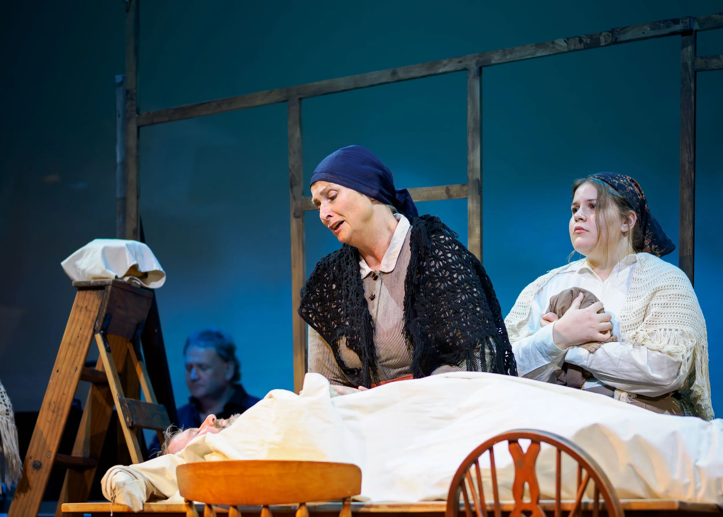 Louisa Pilkington (as Maurya) and Erin Connelly-Whyte (as Cathleen) sing over the body of Bartley (Nigel Withington)
