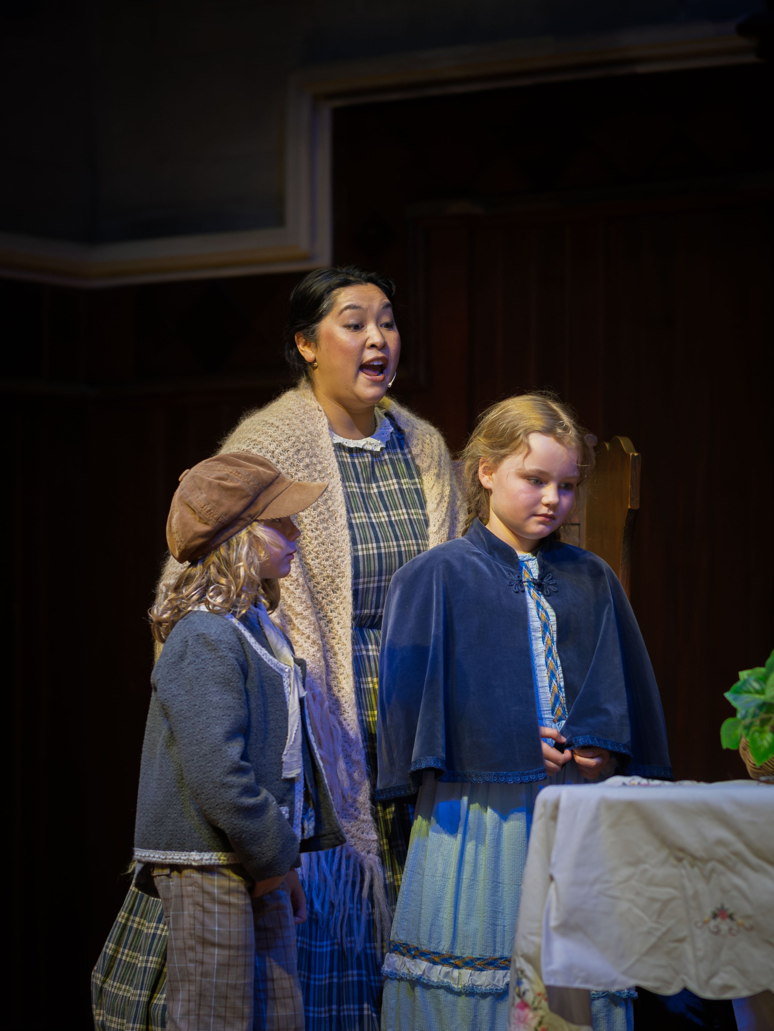 Jamie Hart (Mrs. Cratchit), Robin Keena (Tiny Tim Cratchit), & Rosalind Robinson (Adelaide Cratchit)