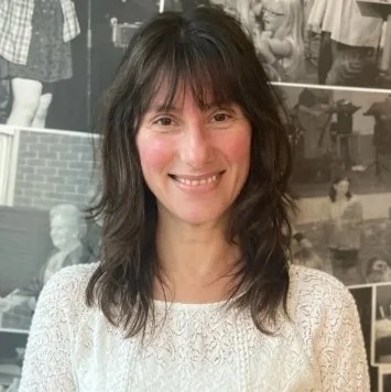 Image of lady in white jumper and dark hair