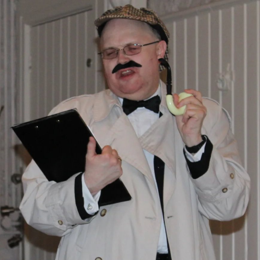 comic actor in trench coat and pipe with clipboard