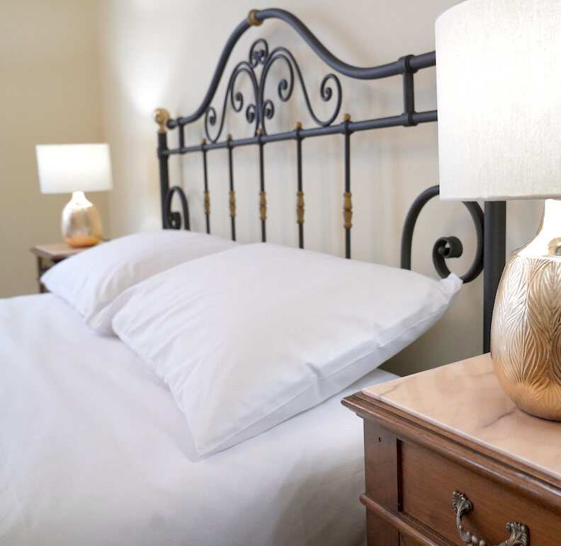 Cast iron bed with antique nightstands