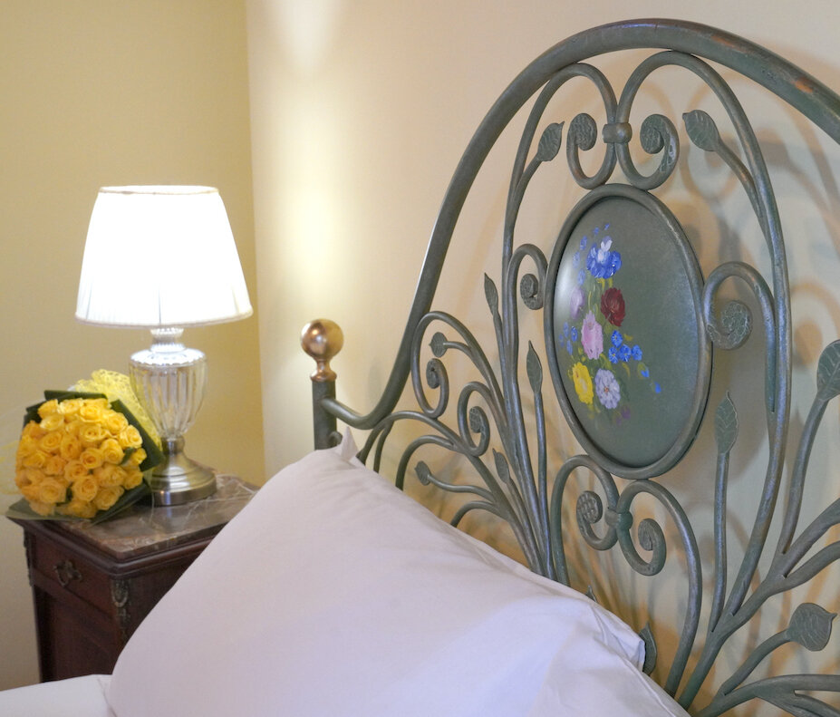 Decorative hand-painted headboard of antique iron bed 