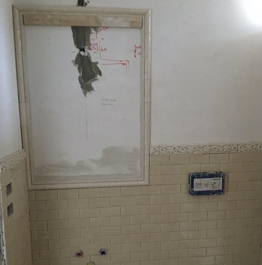 Unfinished bathroom with empty space for the wall mirror