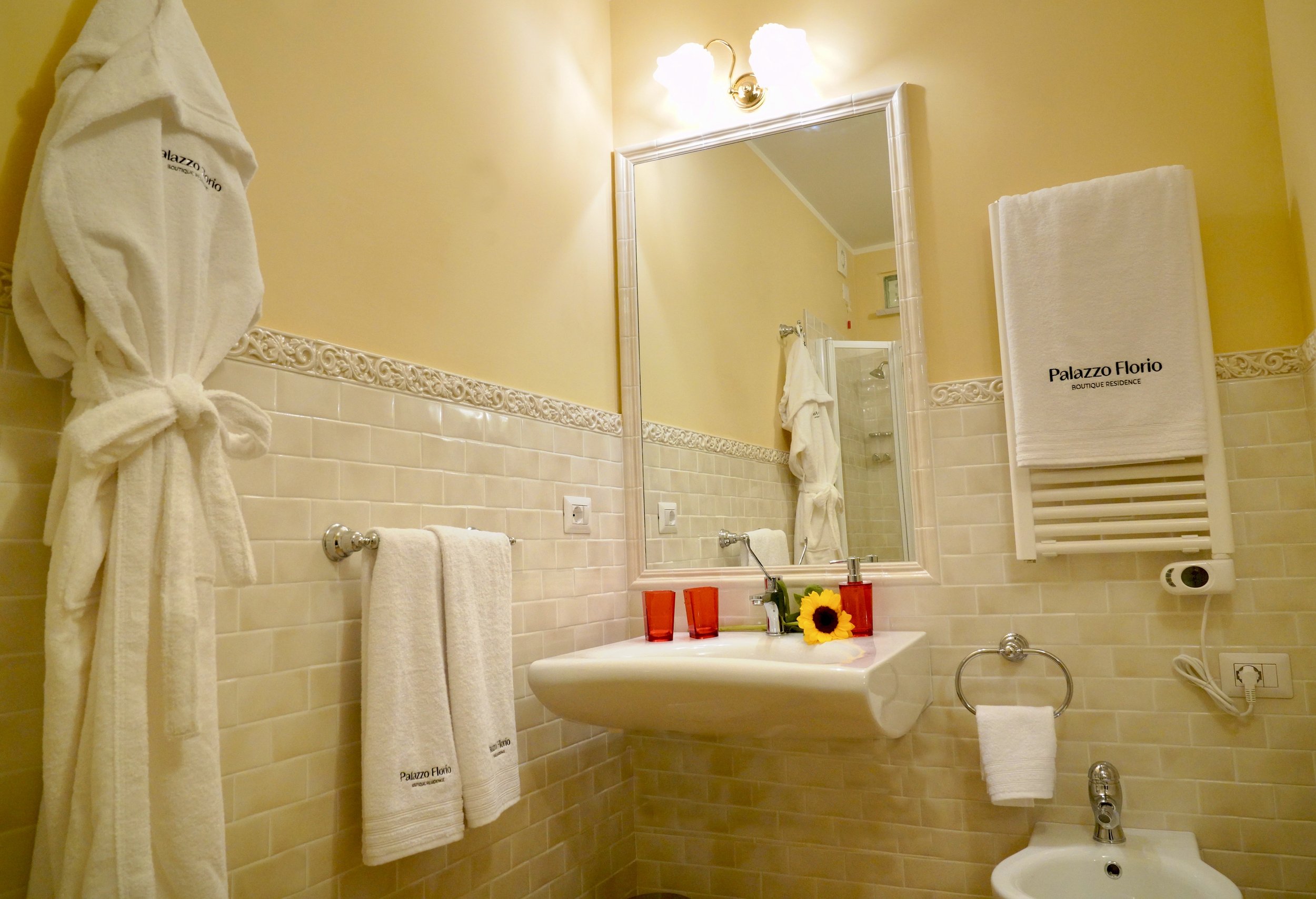 Bathroom facilities with embroidered towels and bathrobe