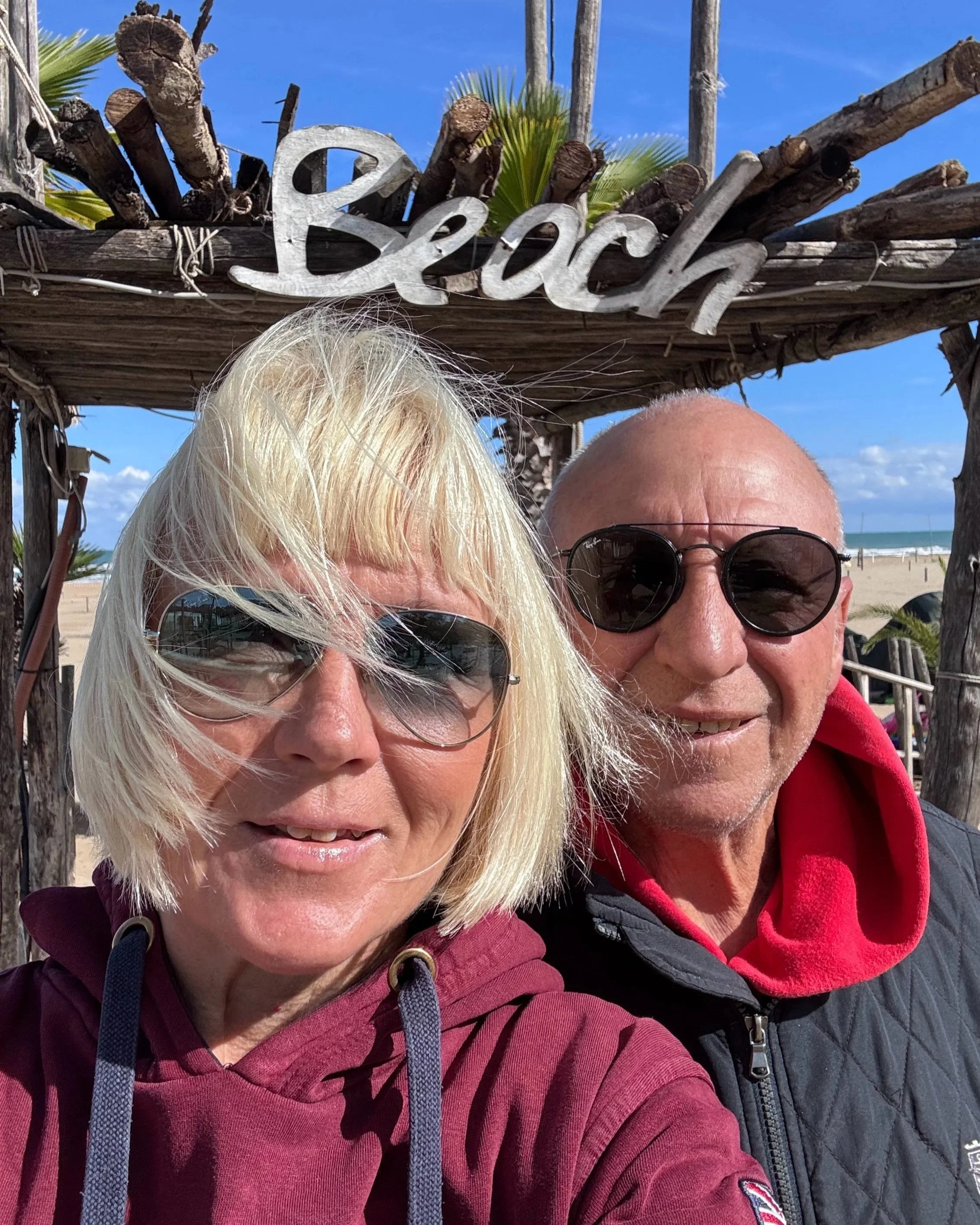 a selfie of Anita and Umberto on a windy beach
