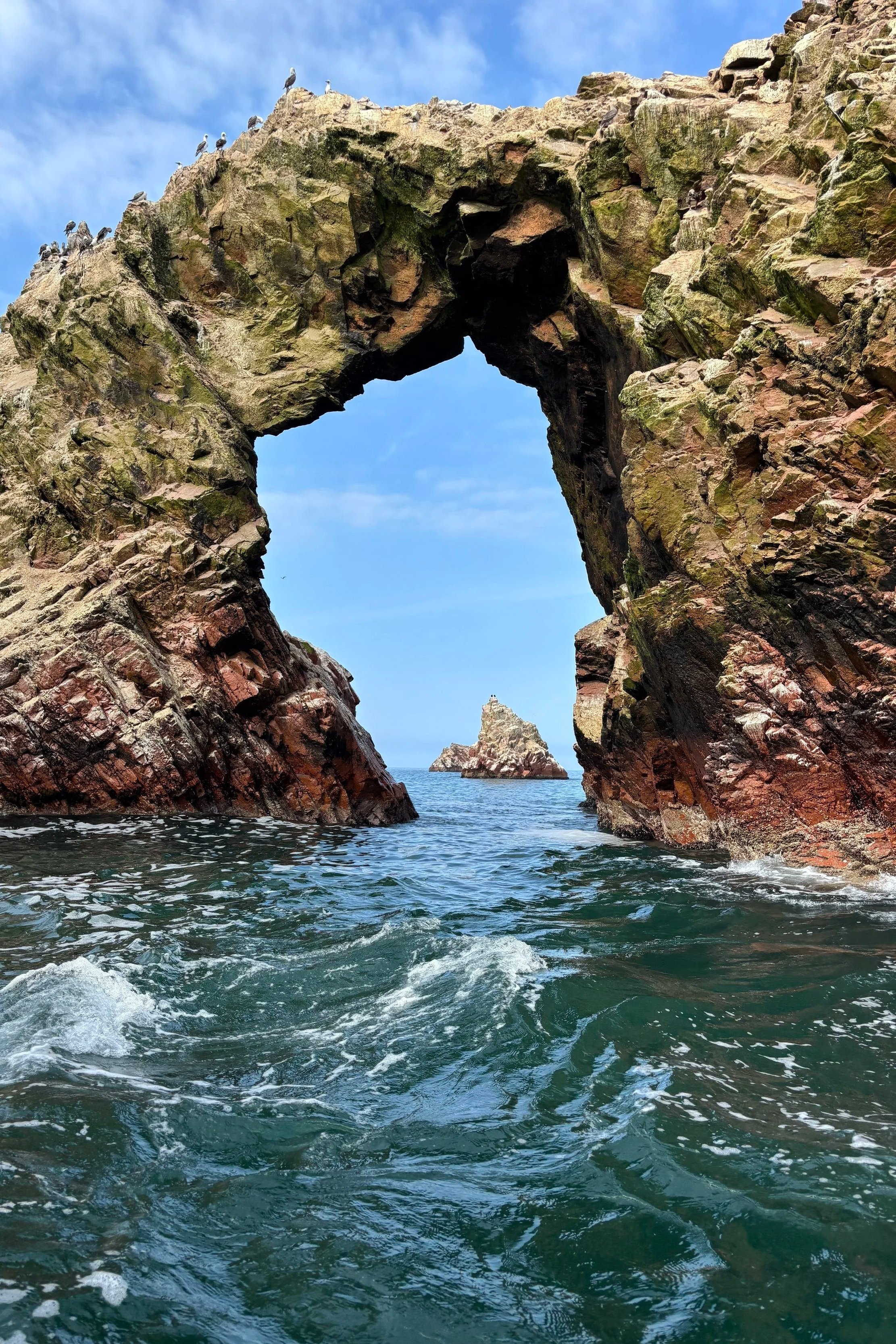 Rock formations jutting out of the Pacific Ocean in the Ballestas Islands in Peru