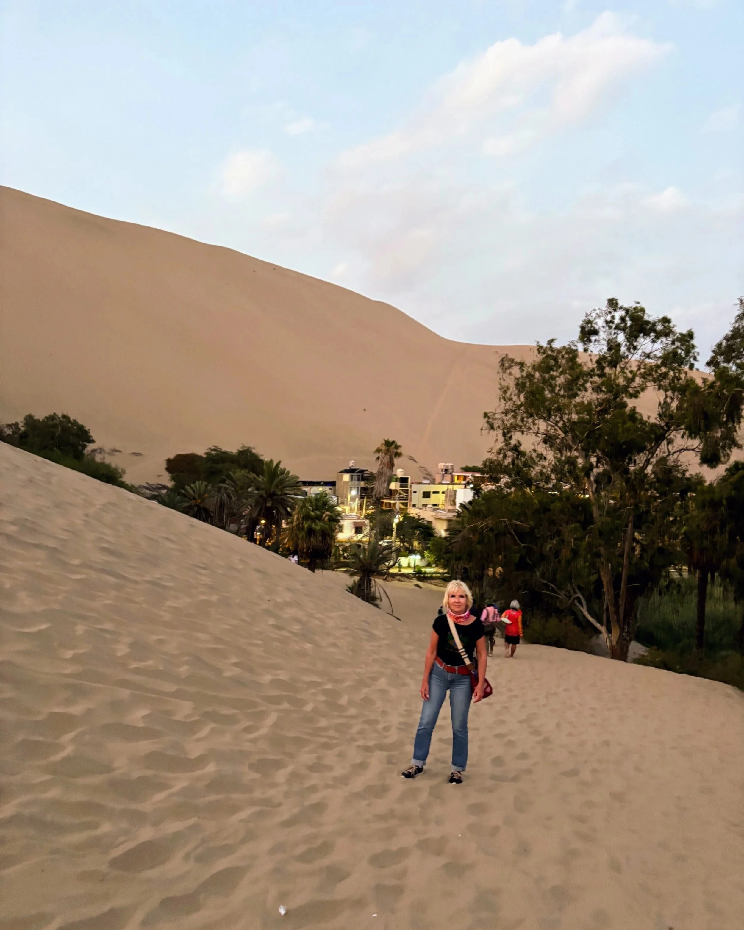 Anita in front of Huacachina oasis in the desert desert Peru.jpg