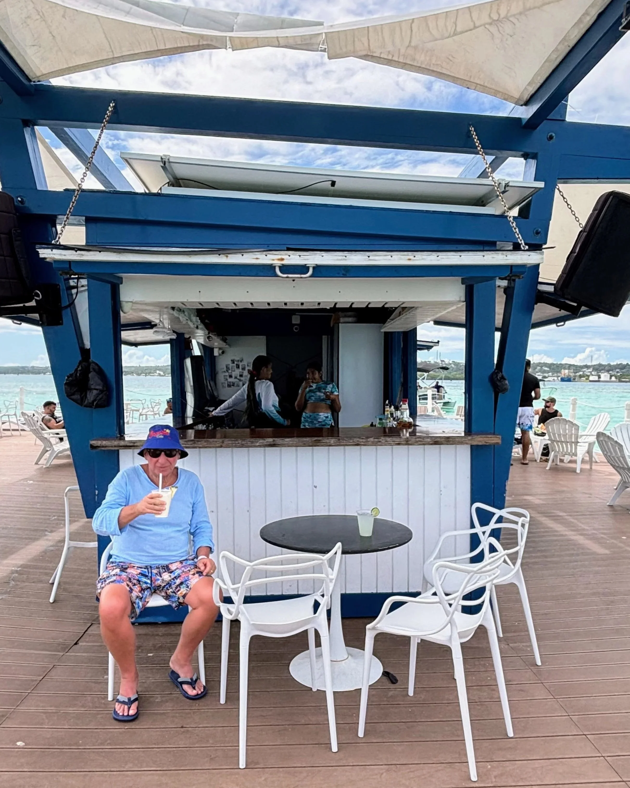 Umberto sipping a drink in front of the bar at the floating beach club.