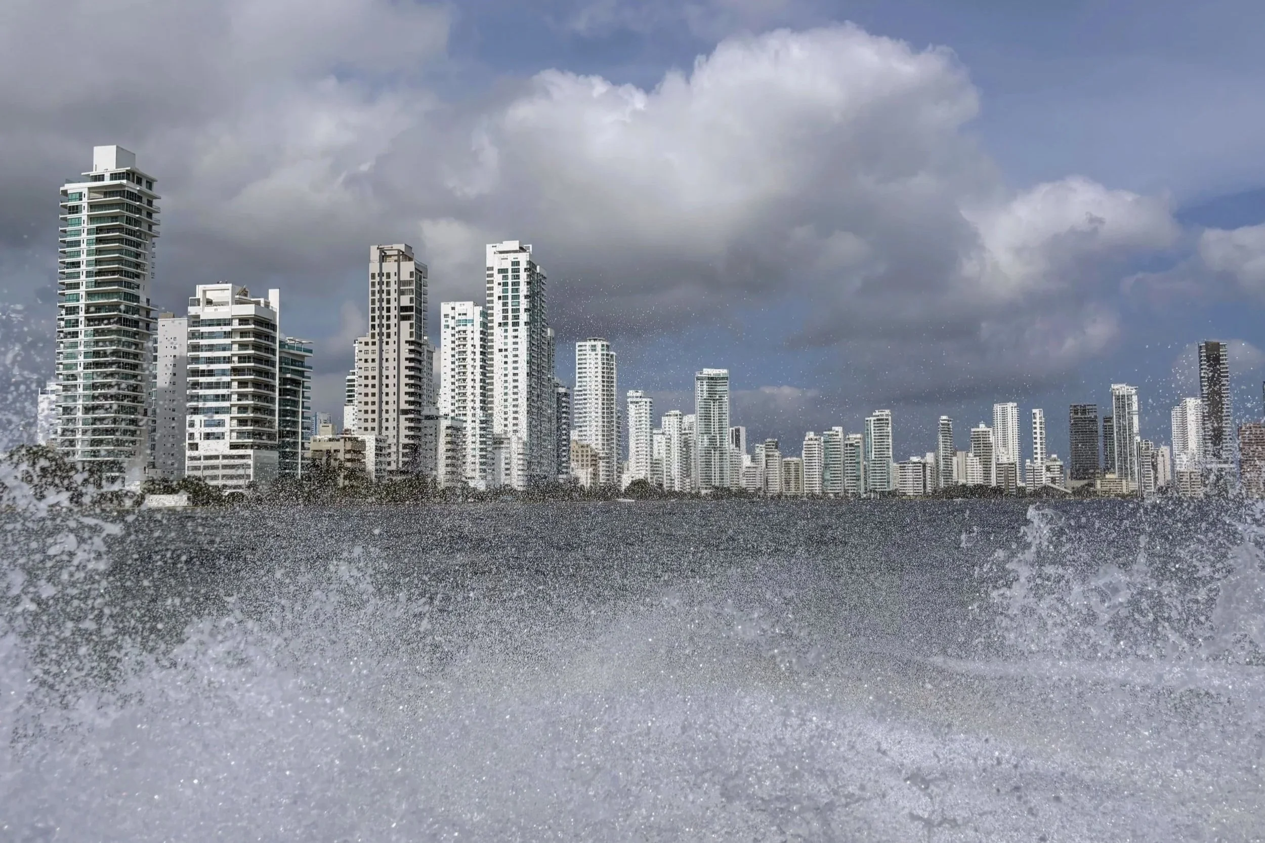 Bocagrande high rise buildings behind splashes of water created by a speedboat