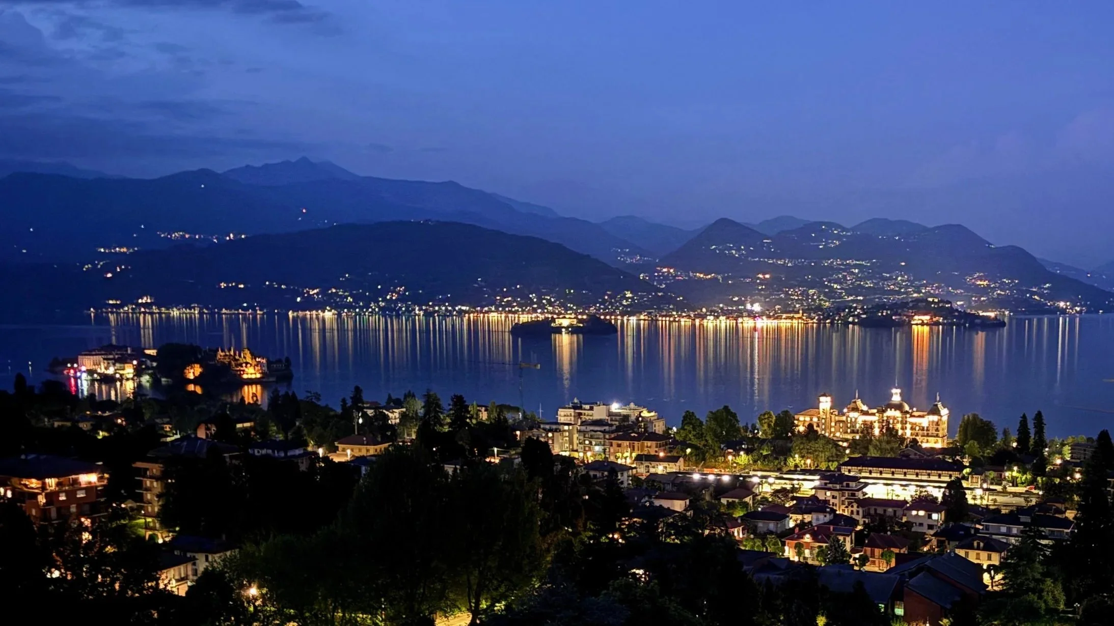 Night time panoramic view  of Lago Maggiore with beautifully illuminated Isola Bella and Grand Hotel des Iles Borromées