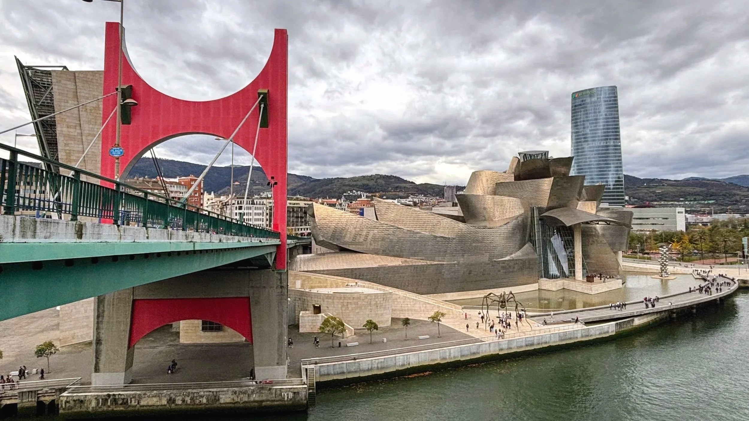 Guggengeim Bilbao seen from La Salve bridge, with the bridge's stucture visible on the left hand side of the photo