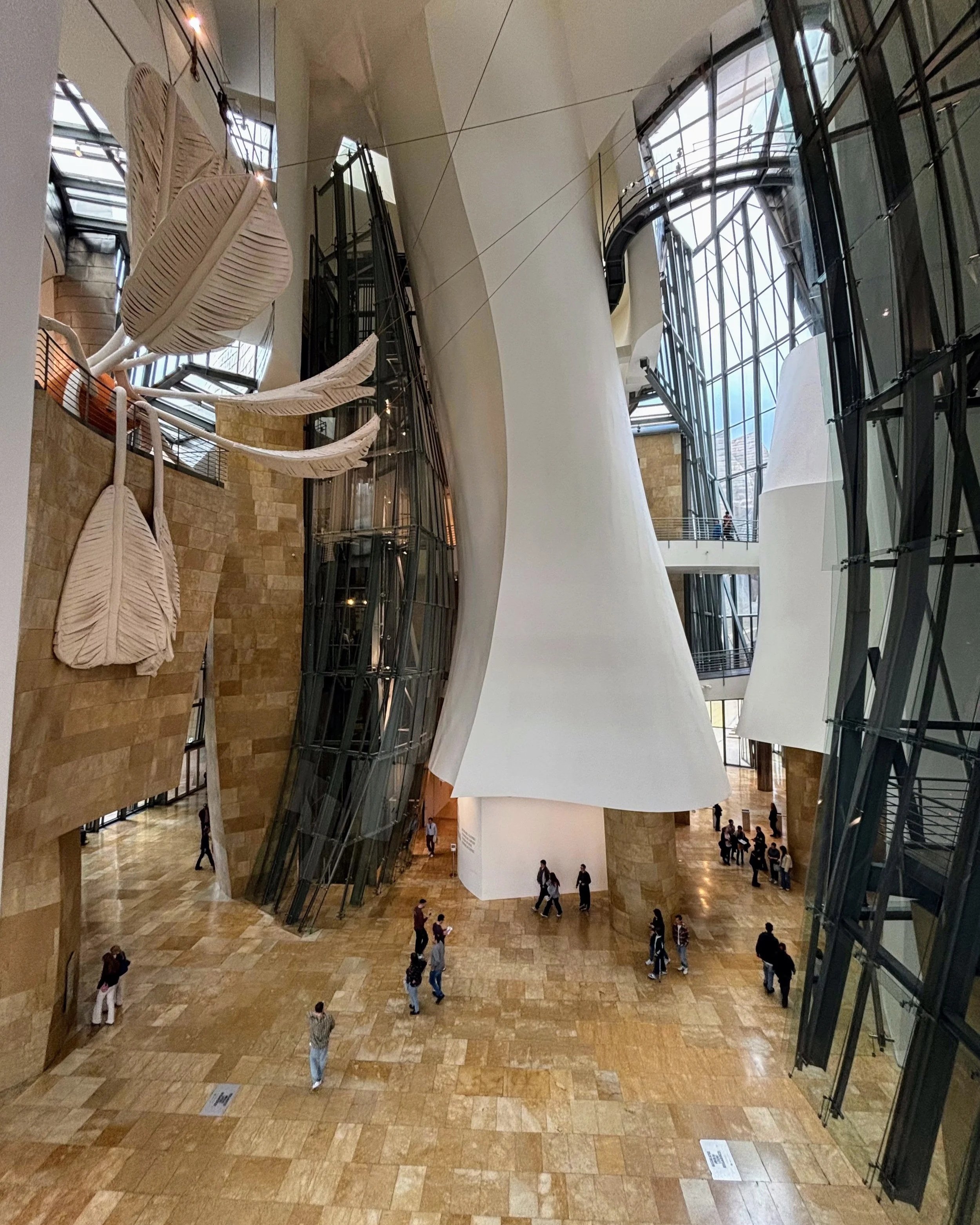 an interior view of Guggenheim Bilbao, taken from an upper level of the lobby space