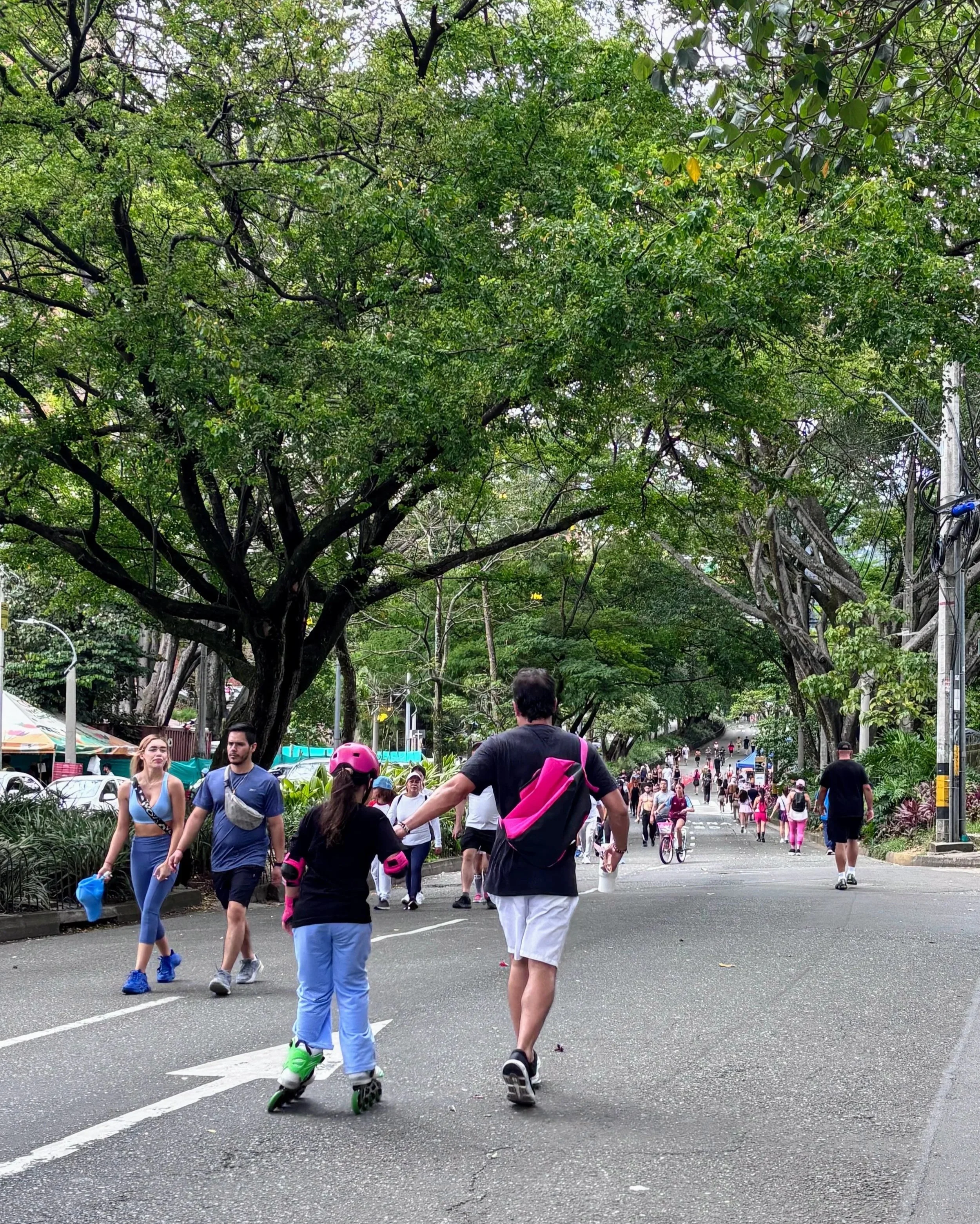People walking and running on the street during Sunday "Ciclovia" in central Medellin Colombia
