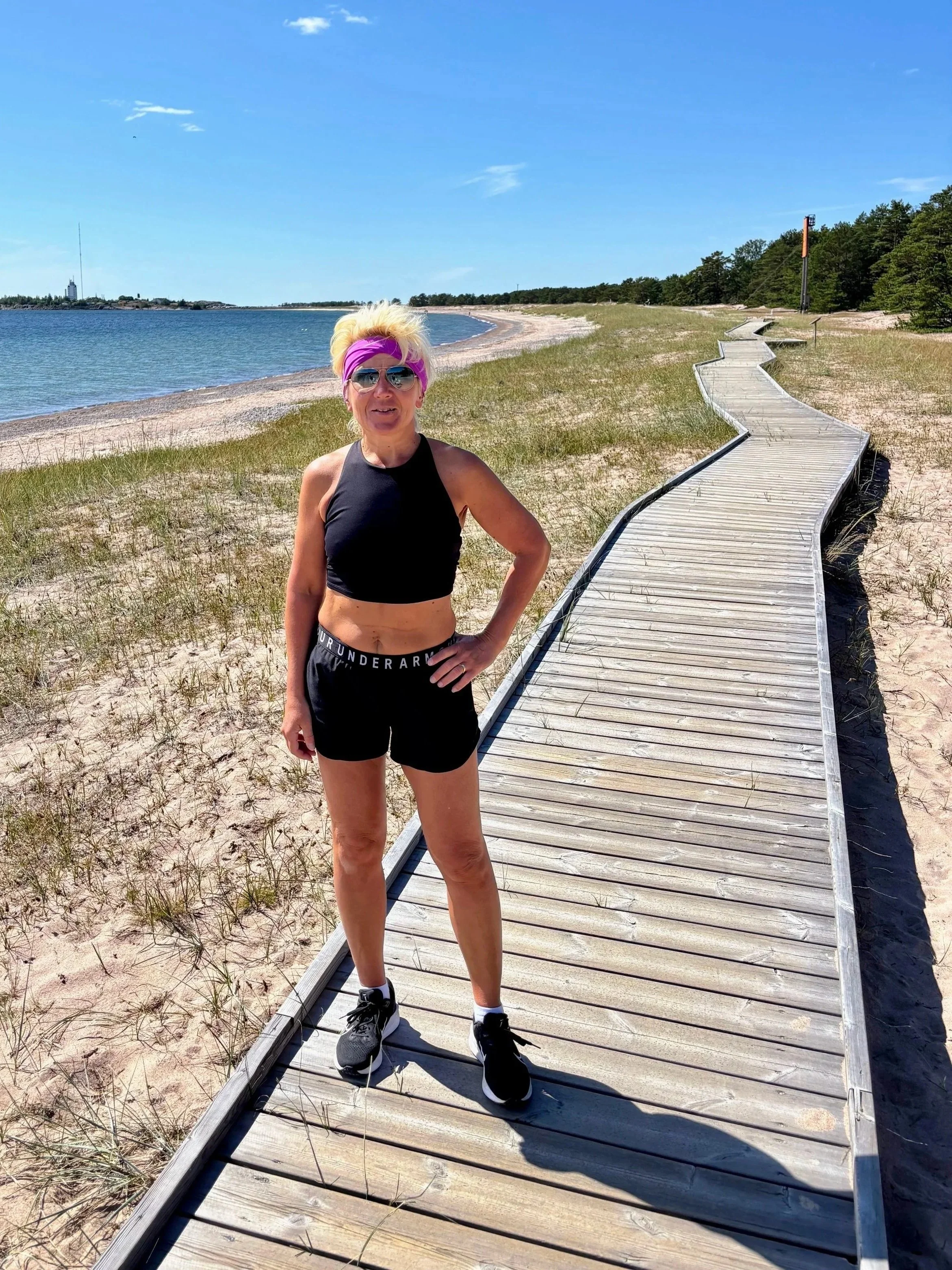 Anita on a wooden walkway on the beach in Hanko Finland