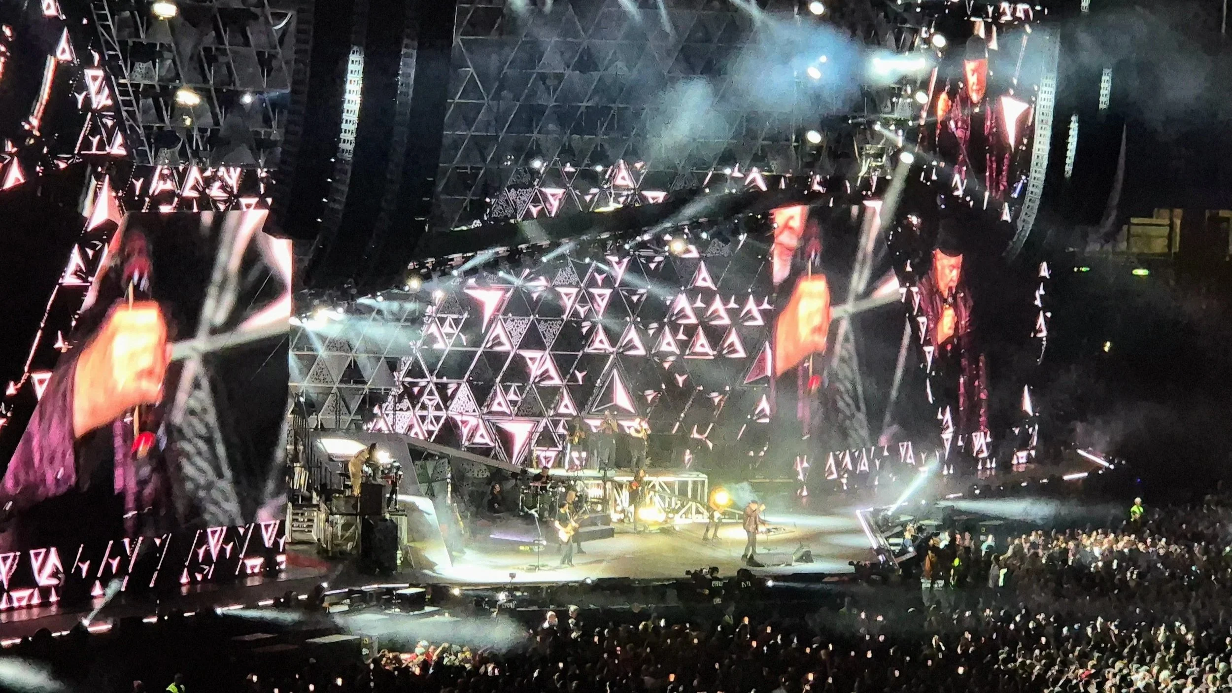 Vasco Rossi on stage with a light show on the screens behind him at the concert at San Nicola stadium in Bari