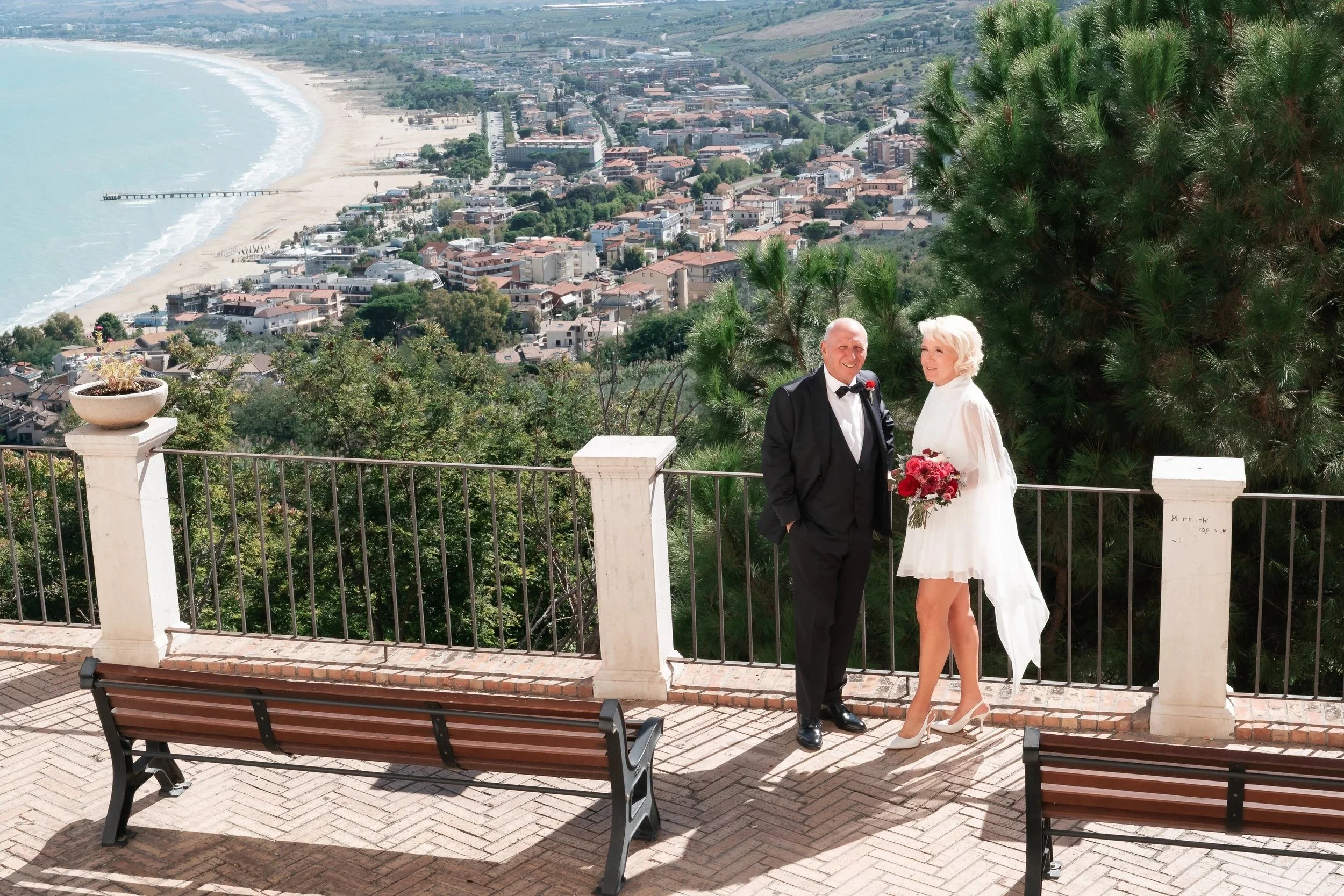 Anita and Umberto on their wedding day at Loggia Amblingh in Vasto with a panorama of the Gulf of Vasto in the background
