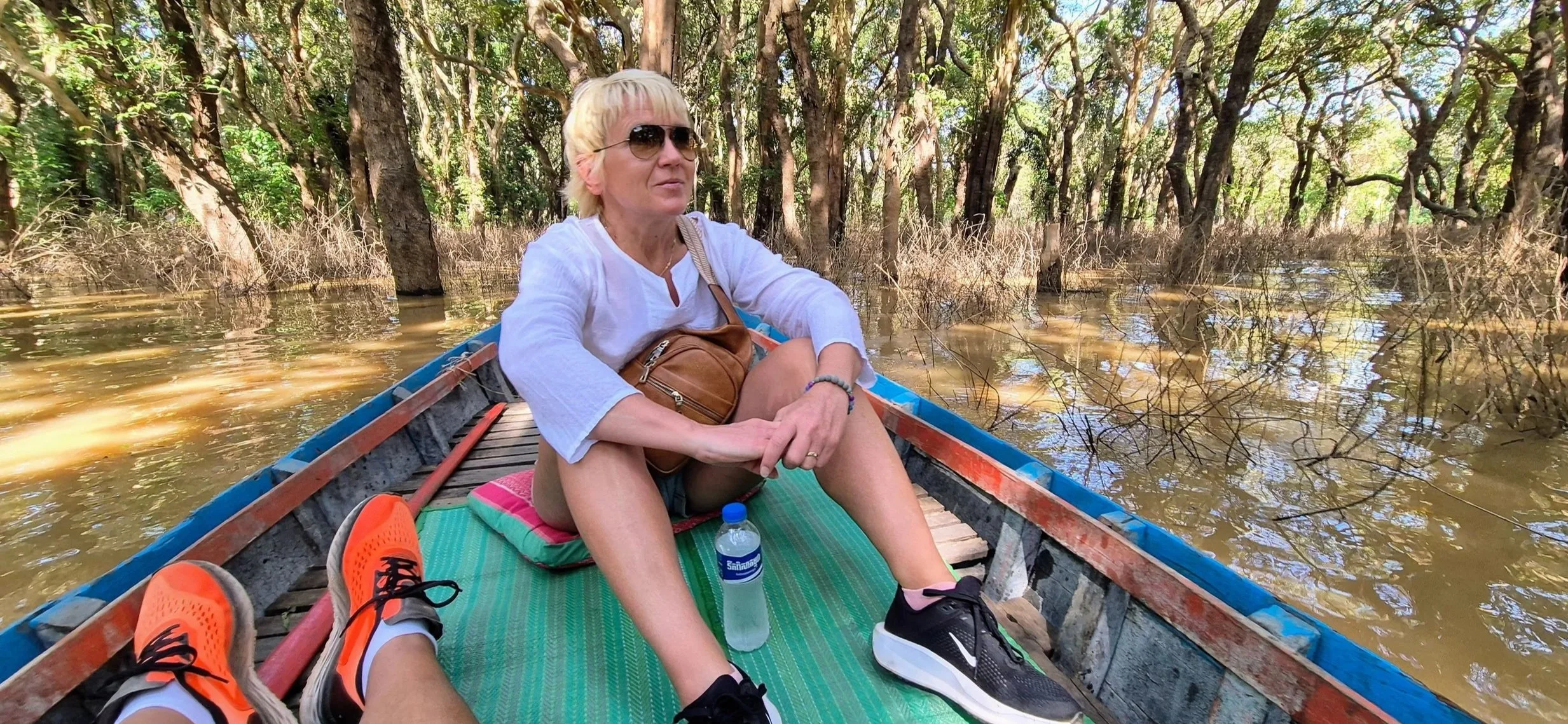Anita on a boat in the flooded mangrove forest in Kampong Phluk Cambodia