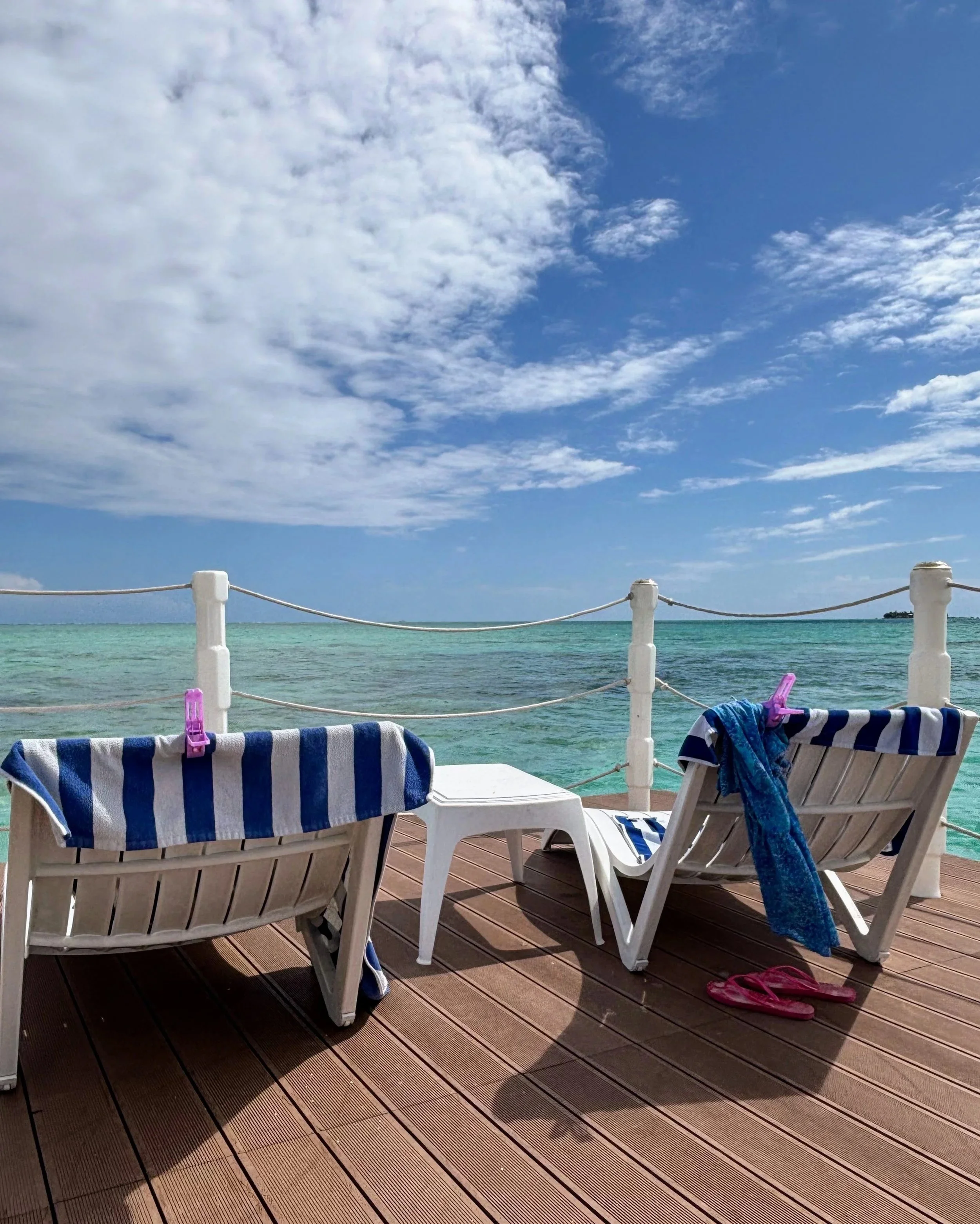 Two sunbeds on a floating wooden beach club in the turquoise sea in  San Andrés Colombia