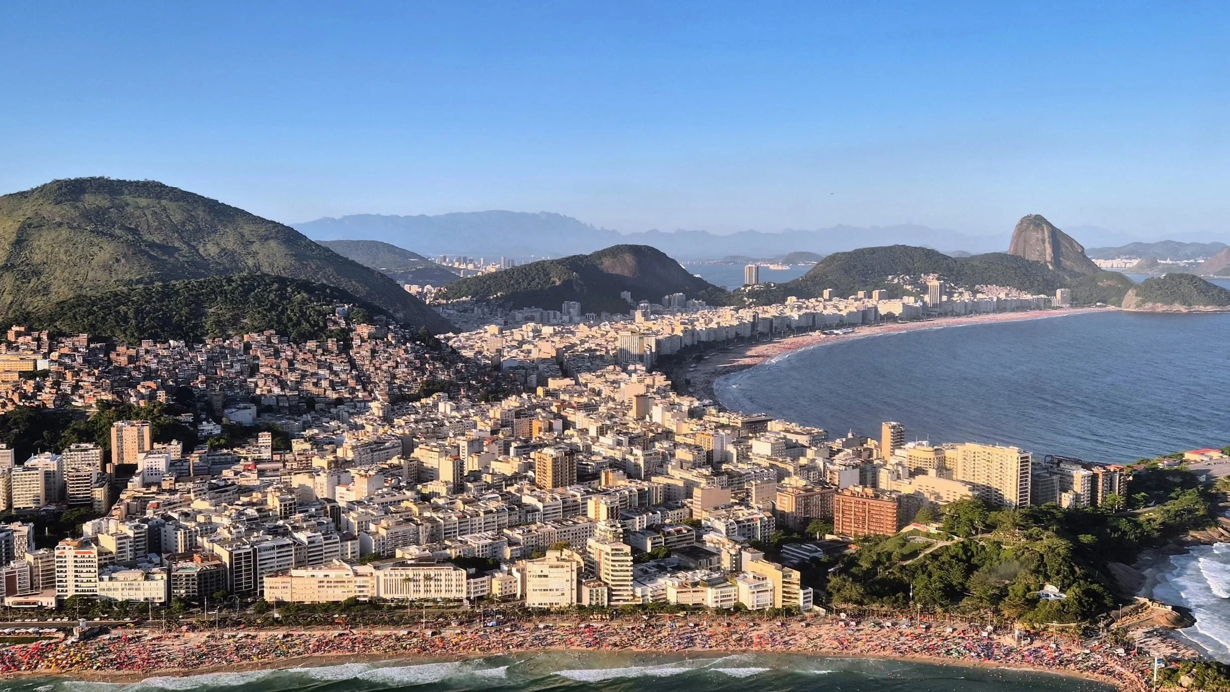 Rio de Janeiro seen from helicopter, with Ipanema in the front and Copacabana in the right and Sugarloaf Mountain in the top right corner.