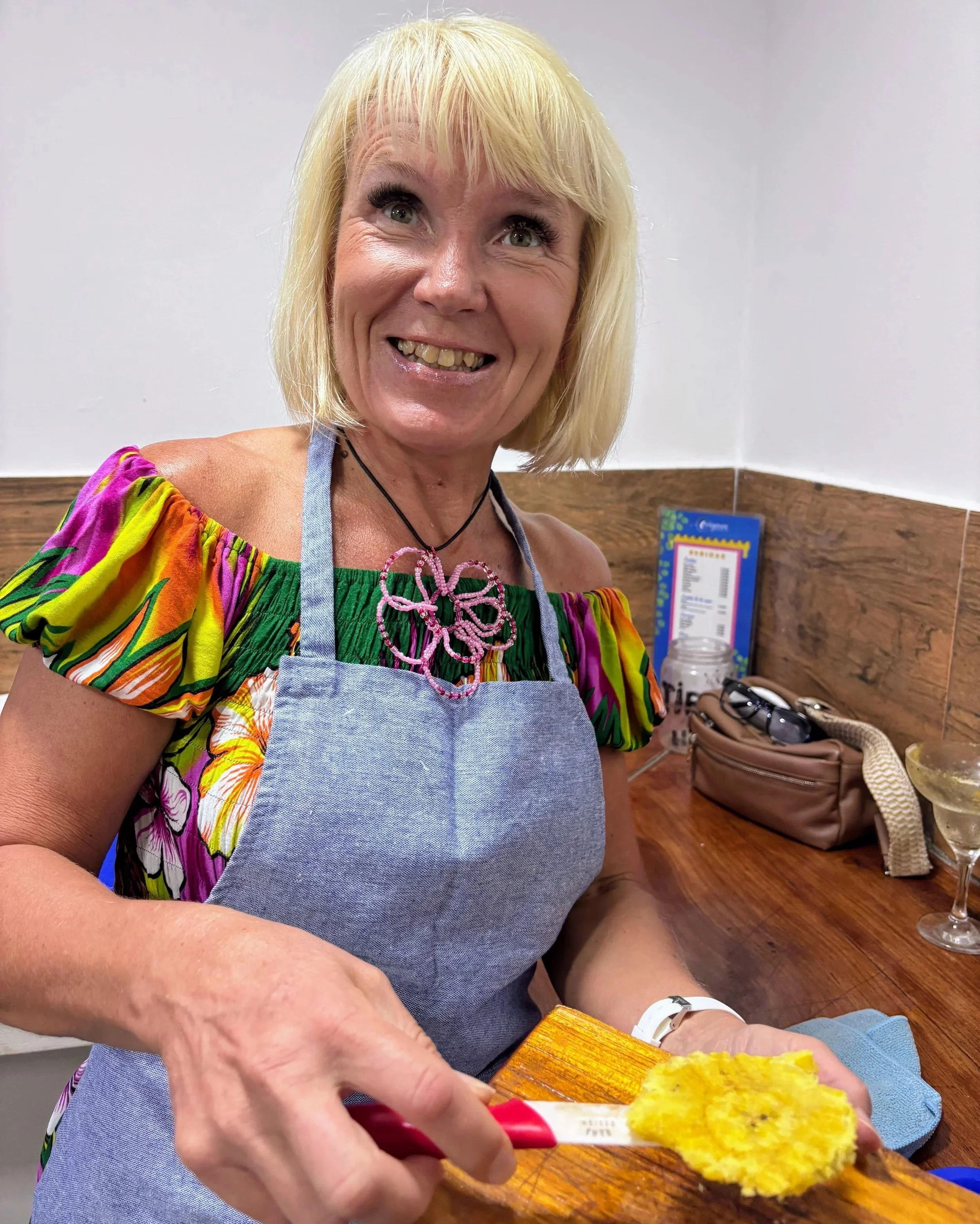 Anita making patacones at a cooking class