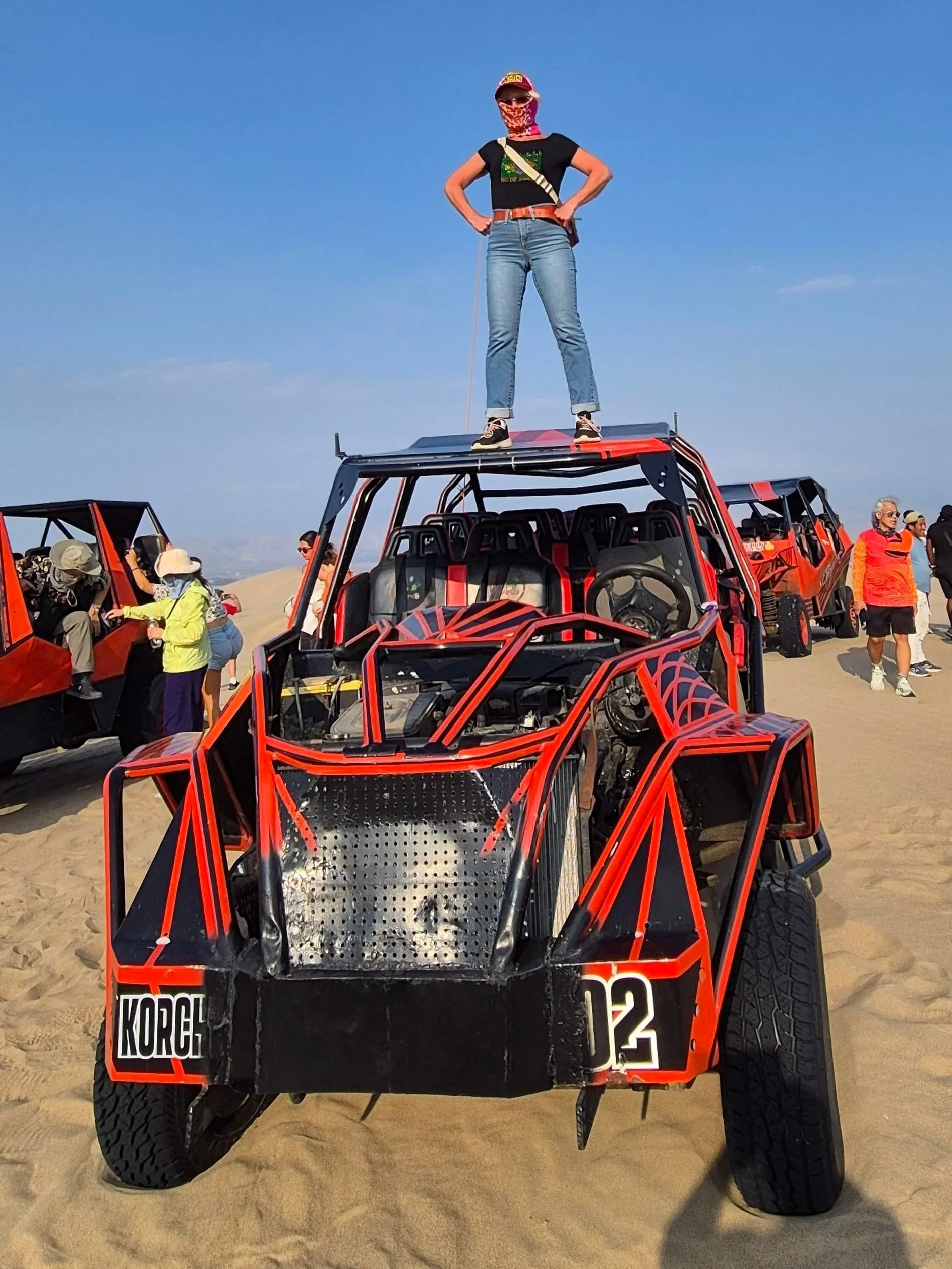Anita standing on top of a sand buggy in Ica desert Huacachina Peru