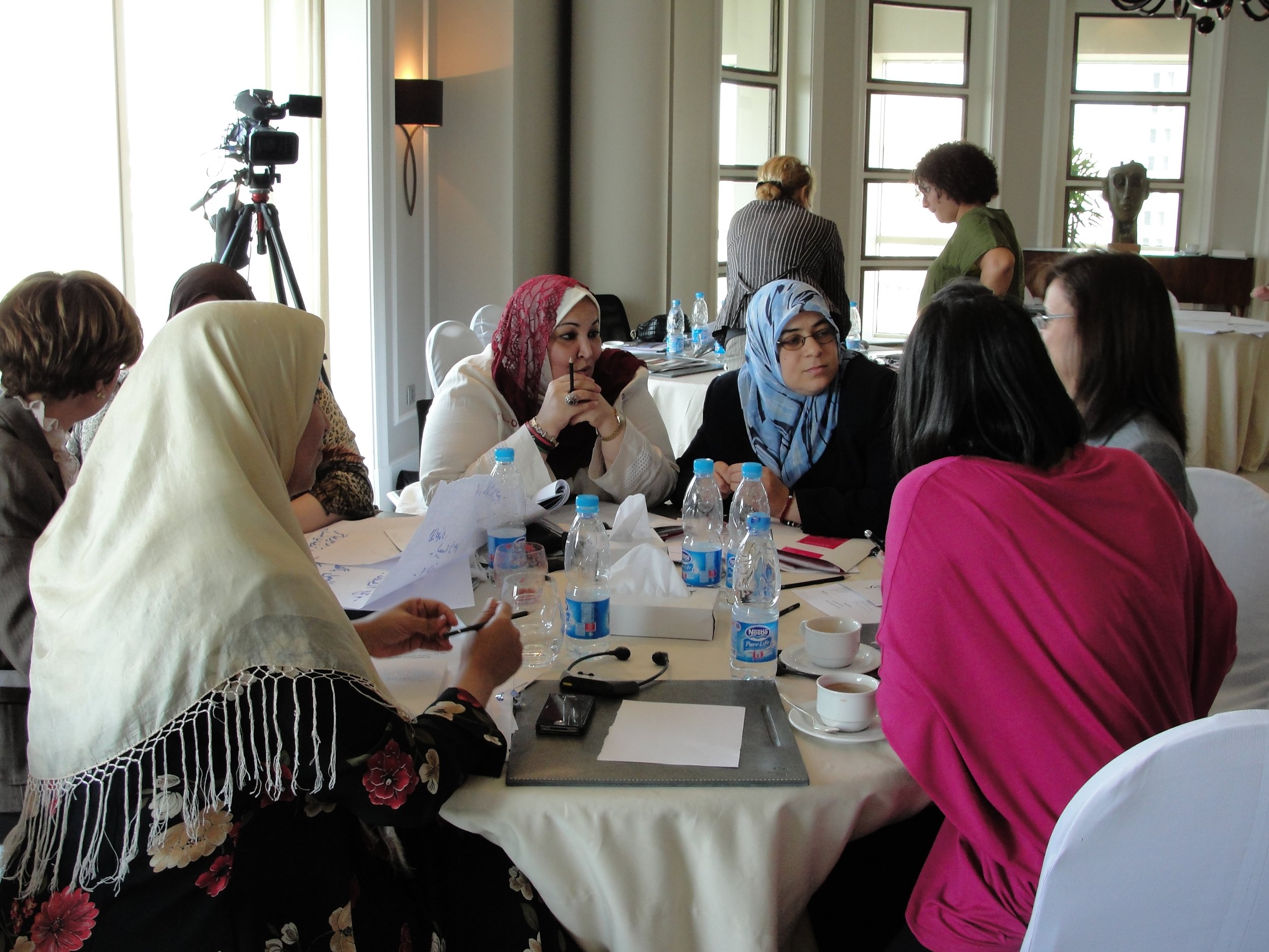 A group of women in discussion around a table