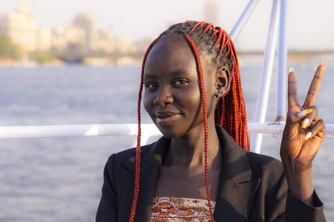 A profile of Aluel Deng making the peace sign