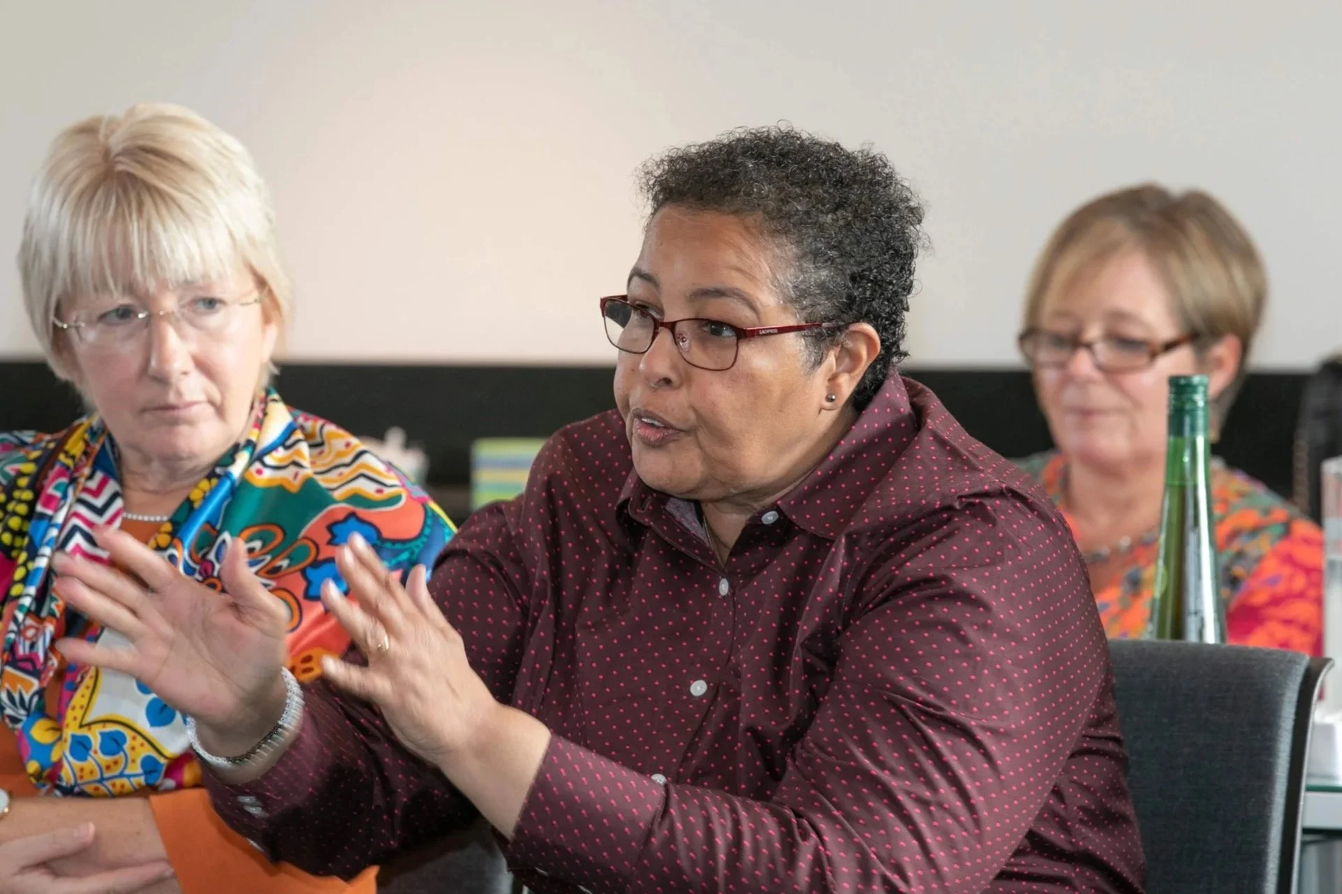 A profile photograph of Faiza Jama Mohamed speaking to a group