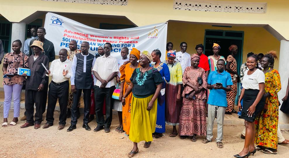 A group of men and women standing in front of a CIGPJ banner 