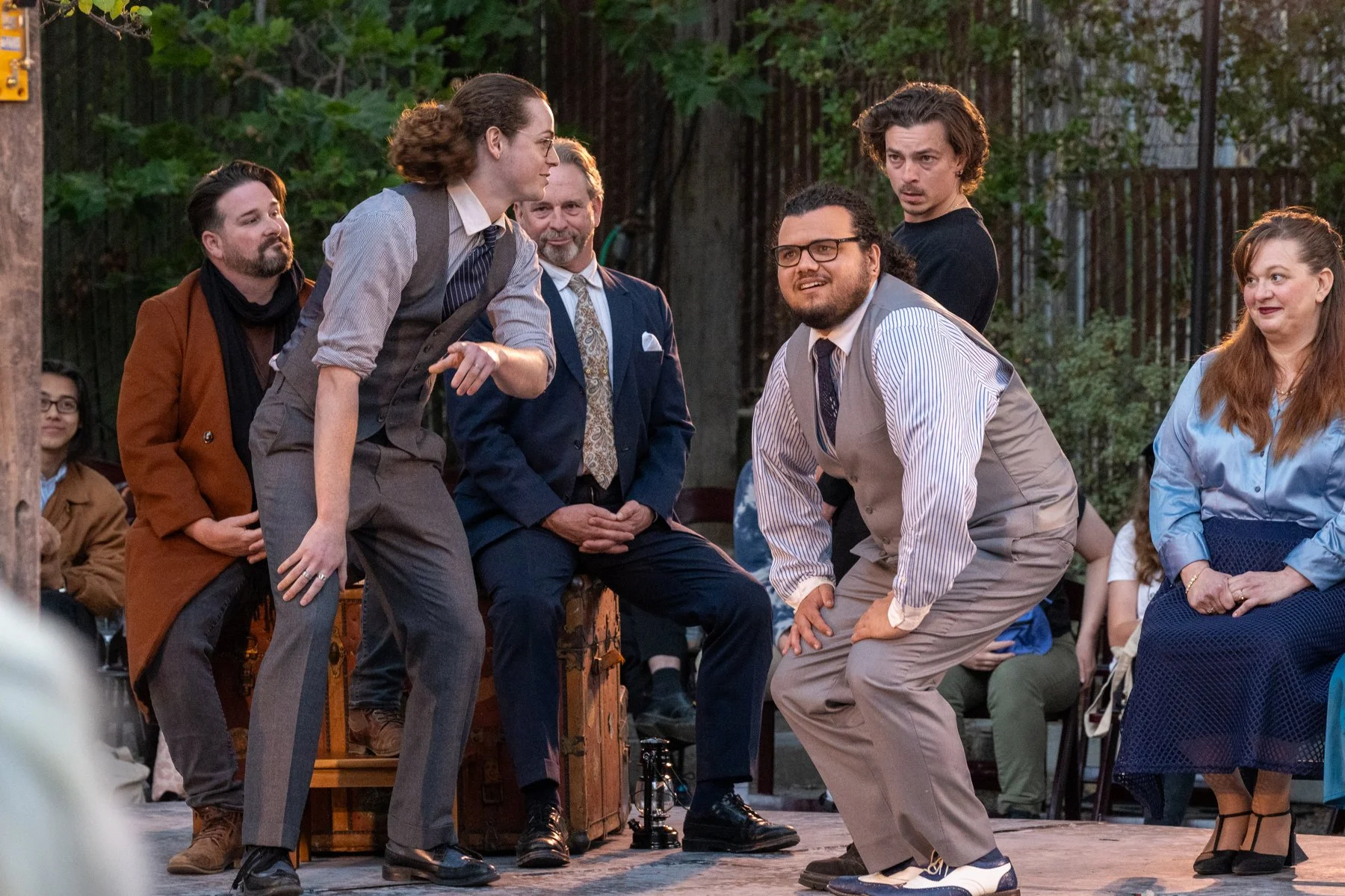 Augus Leslie as Rosencrantz, Xander Young as Guildenstern, Christopher Morson as Hamlet, as the Company looks on. 