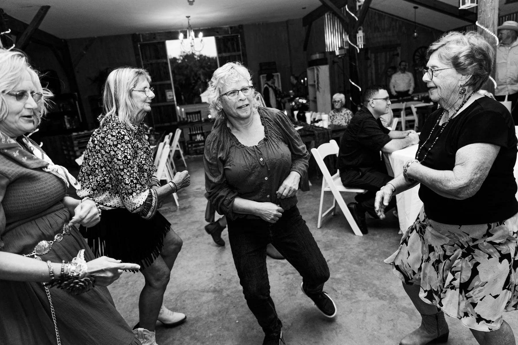 The guests start dancing at the wedding reception.