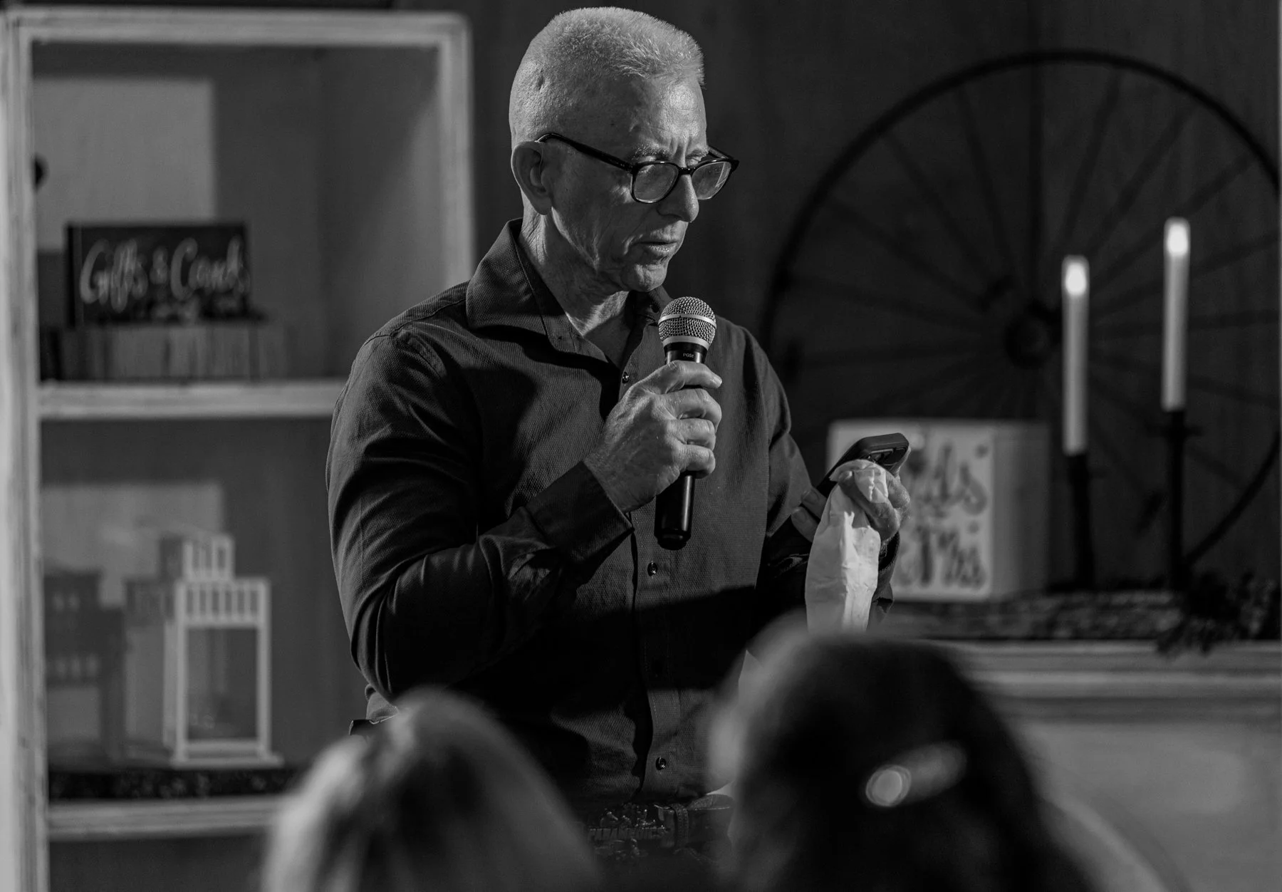 Maddie's father gives a speech at her wedding. He has tissues in hand.
