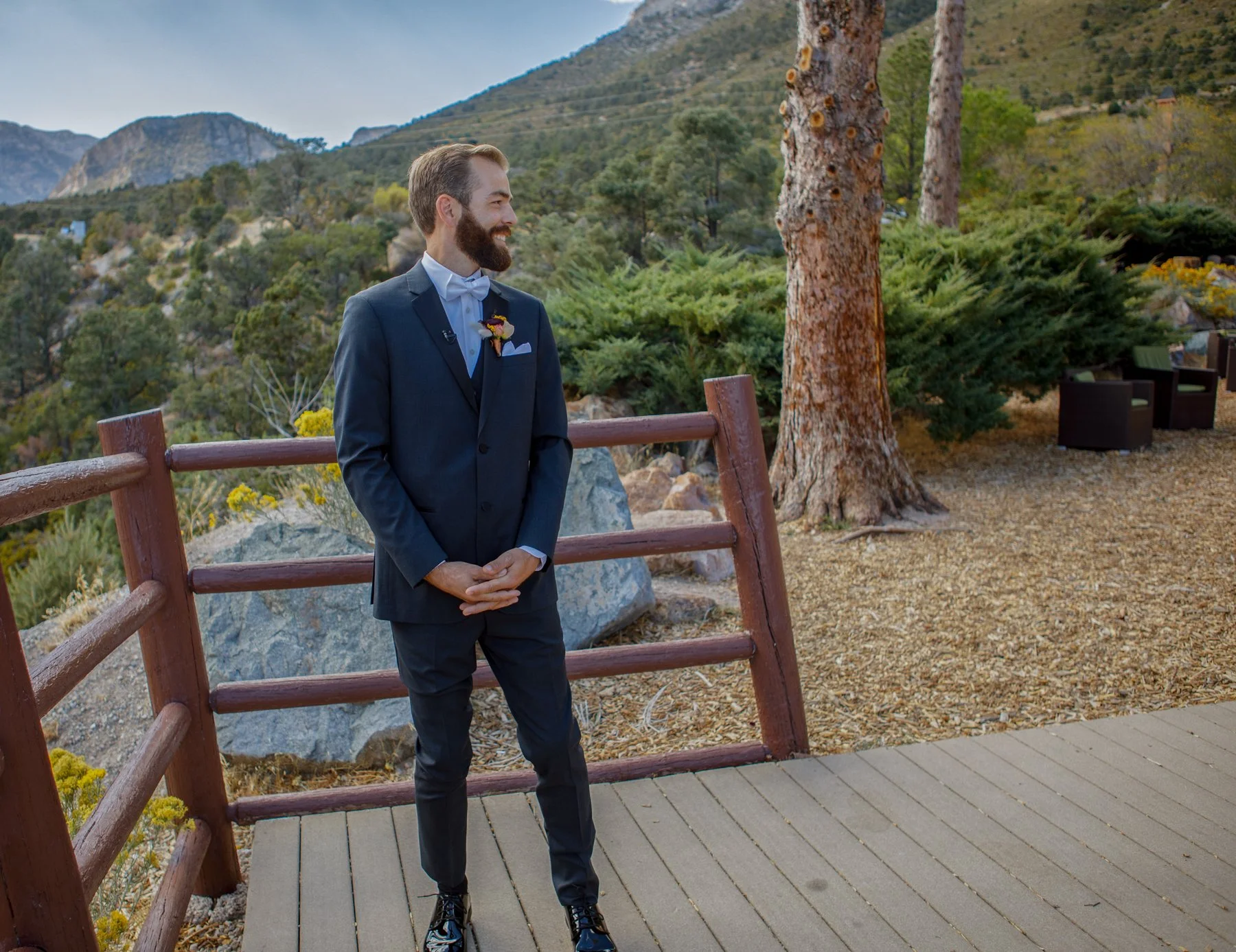 The groom of the wedding is turning to see his family coming up for their first look with him.