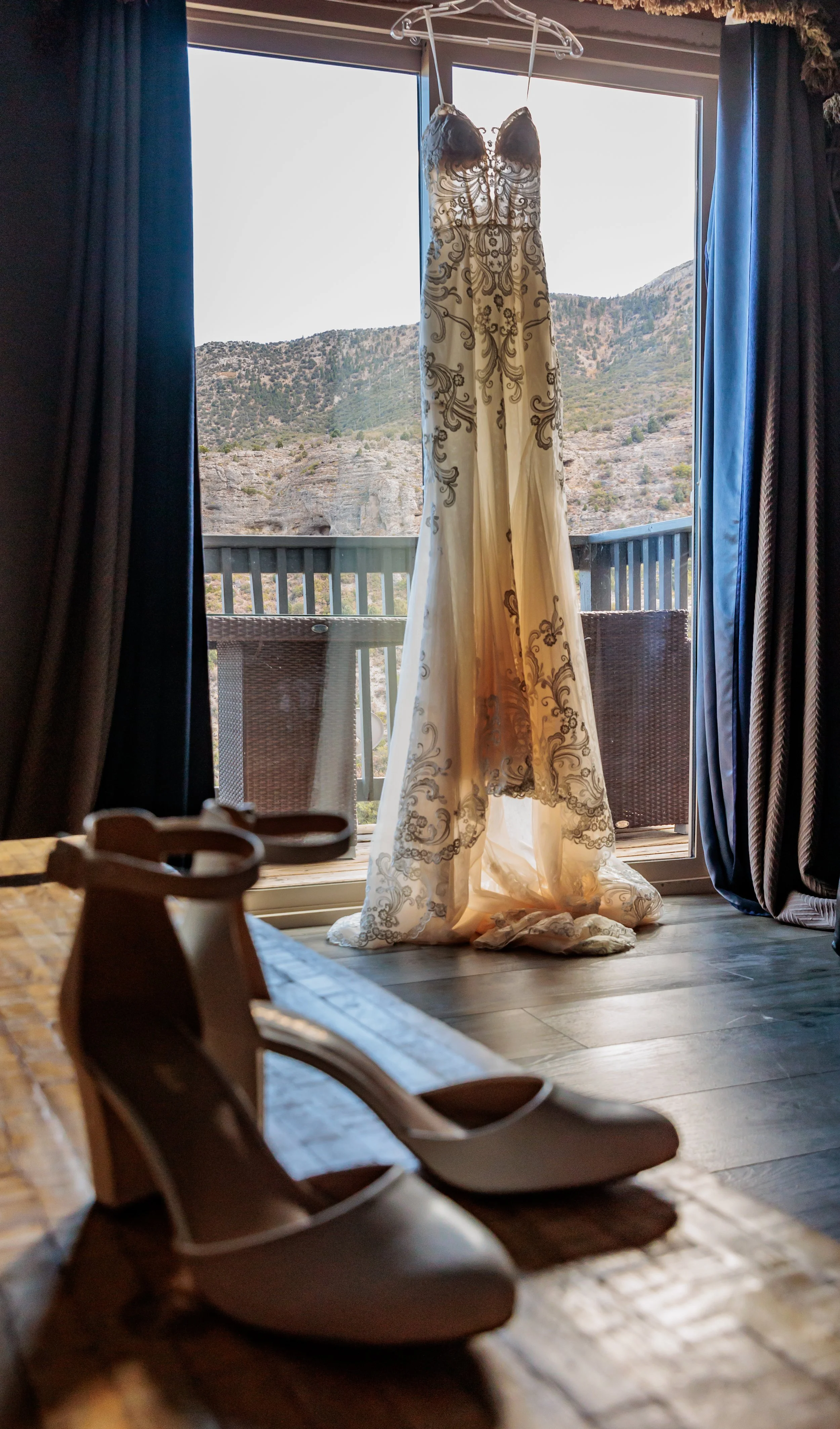 Wedding at Retreat on Charleston Peak wedding dress hanging in front of window with view of mountain