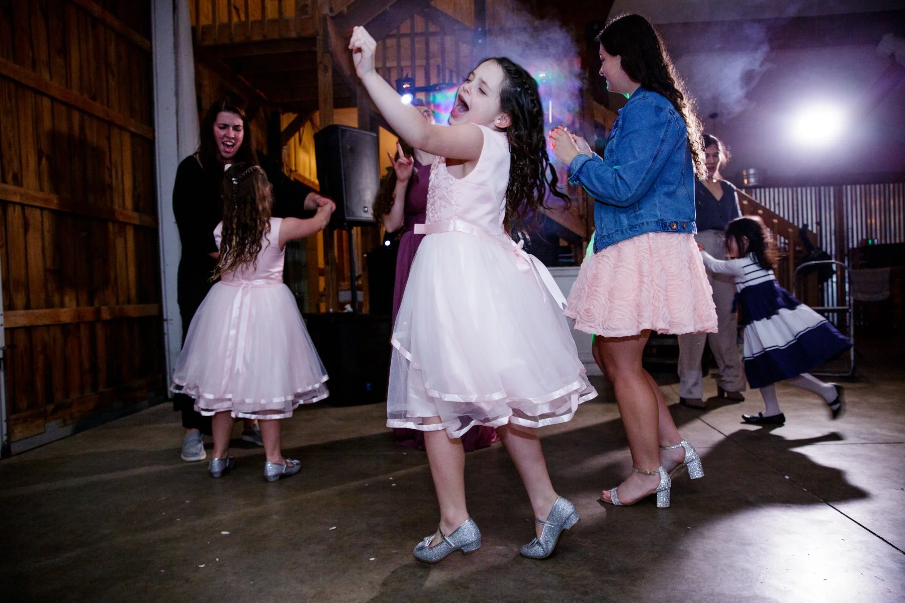 Flower girl dancing at wedding reception.
