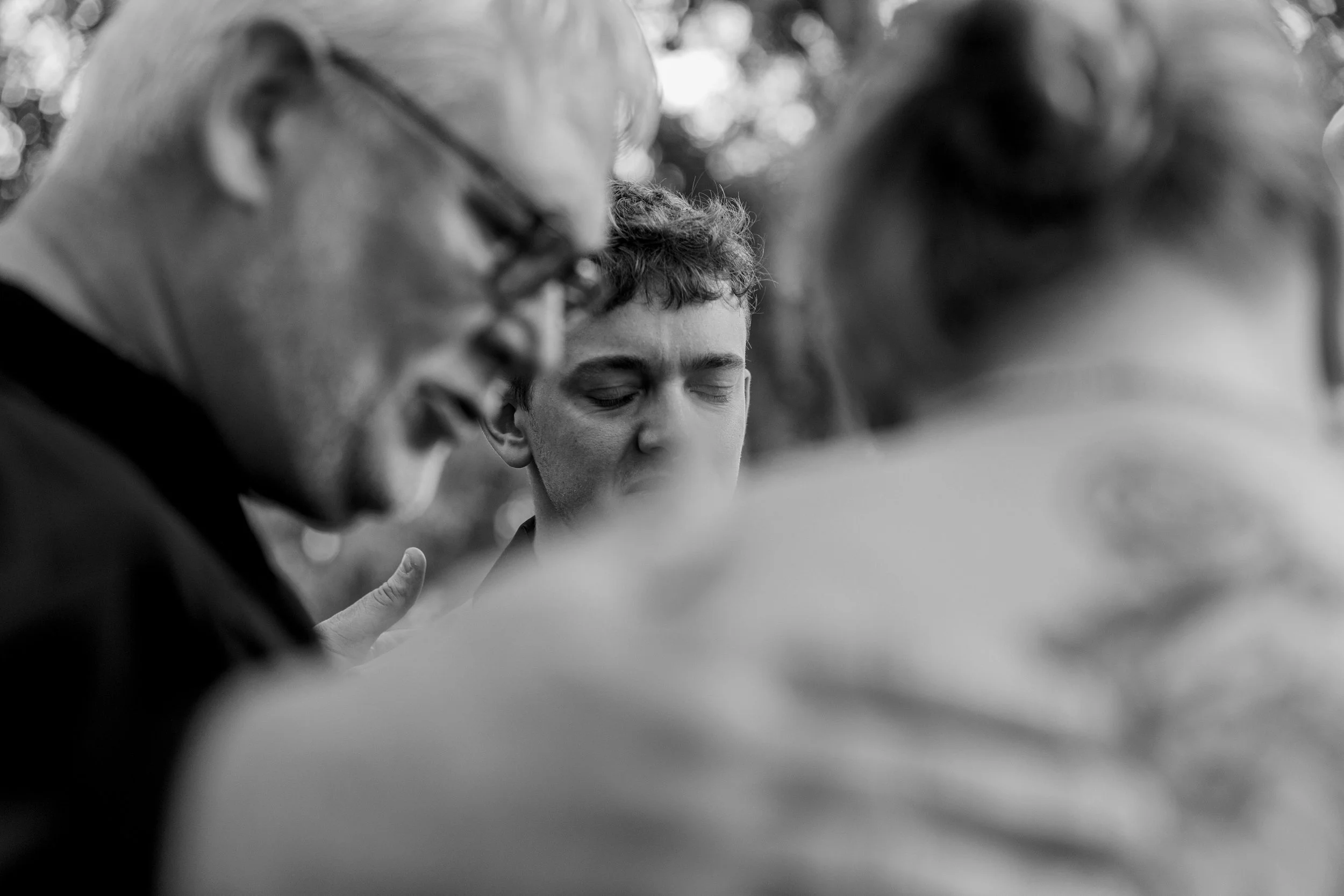 Justyn's best man gets emotional during the wedding party group prayer during their wedding ceremony.