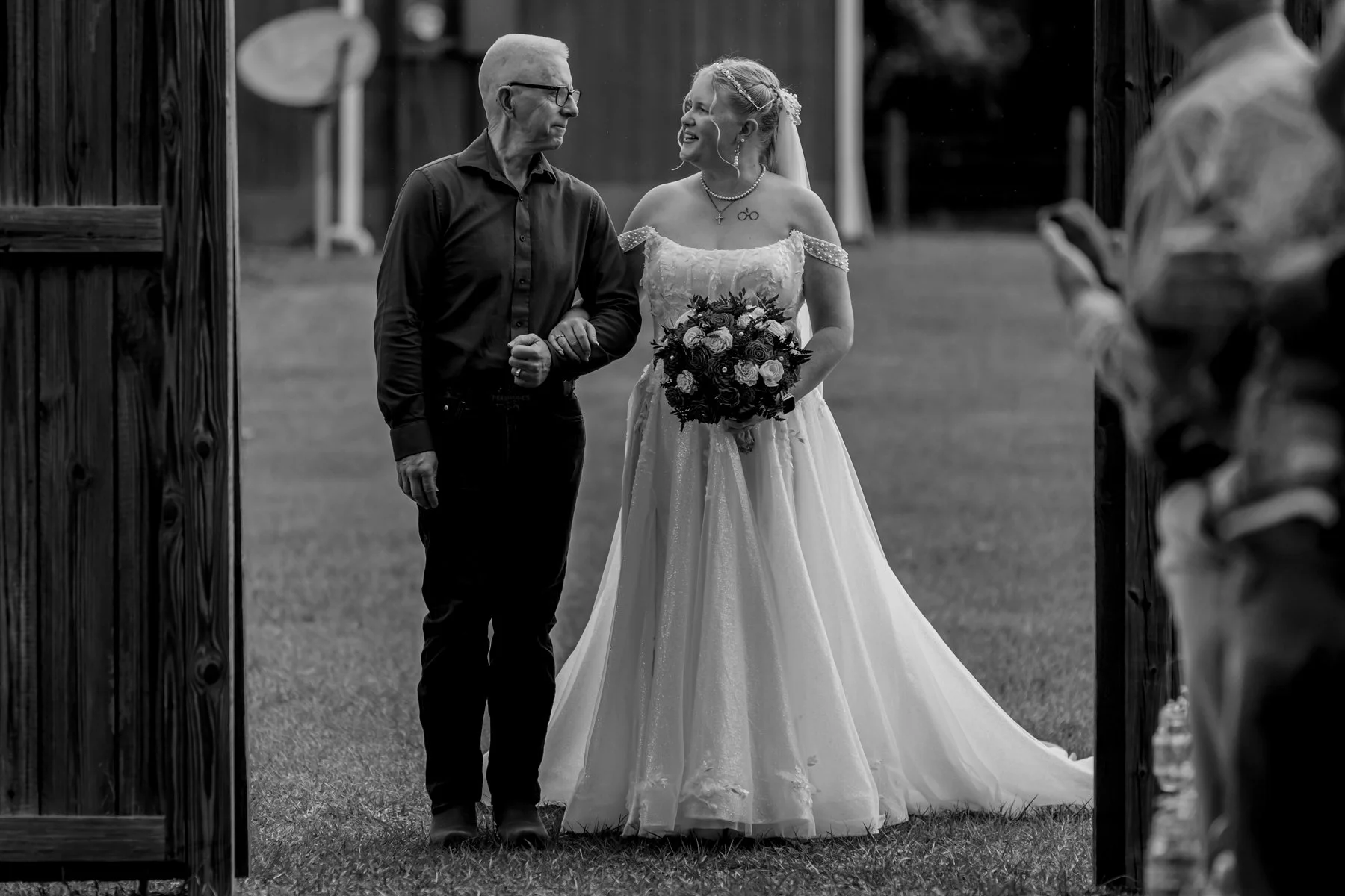 Maddie the bride gets ready to walk down the aisle. She gives her father a look first.