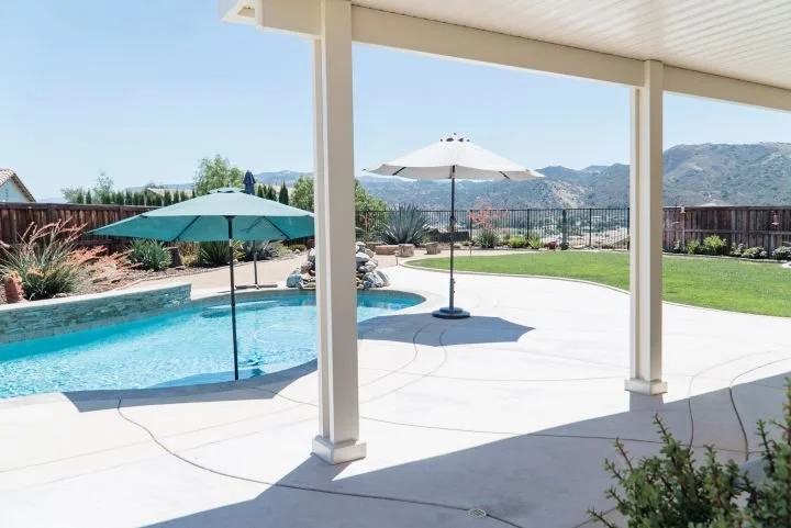 White patio cover posts with AlumaBase installed